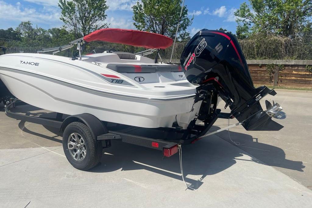 2026 Tahoe T18 boat with red canopy and powerful outboard motor on trailer.