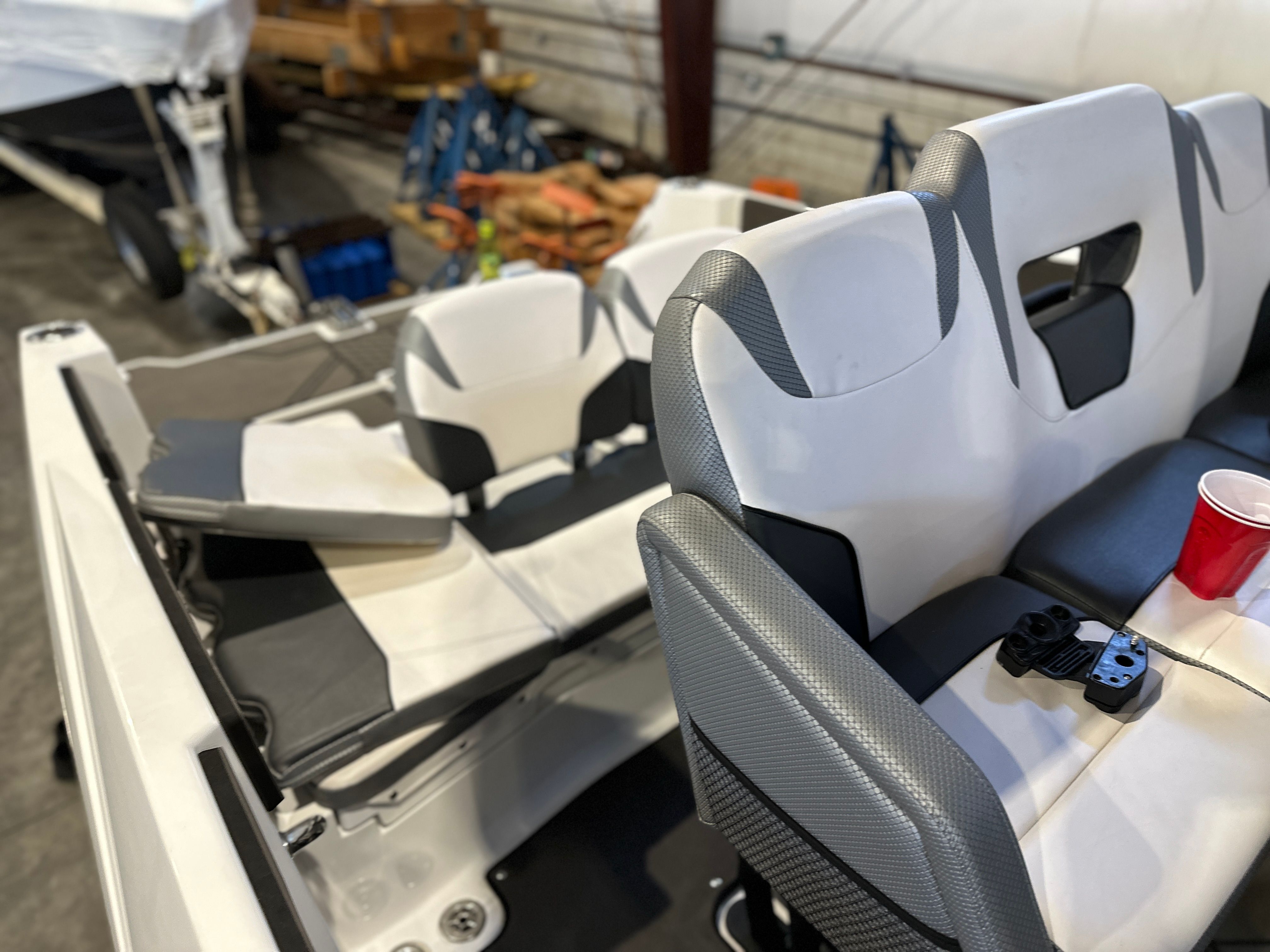 Interior view of a 2021 Scarab 255 Open ID boat with white and gray seating.