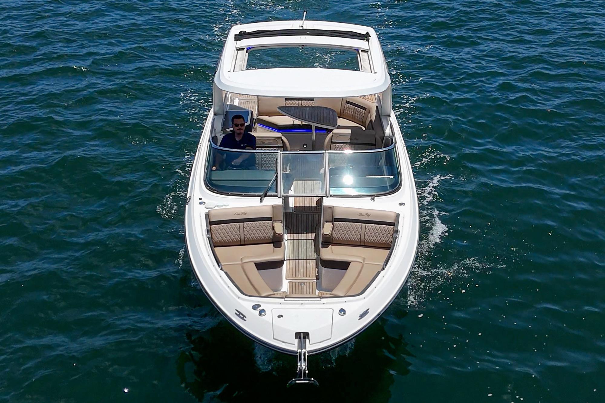 2018 Sea Ray SLX 310 boat cruising on open water, featuring luxurious seating and sleek design.