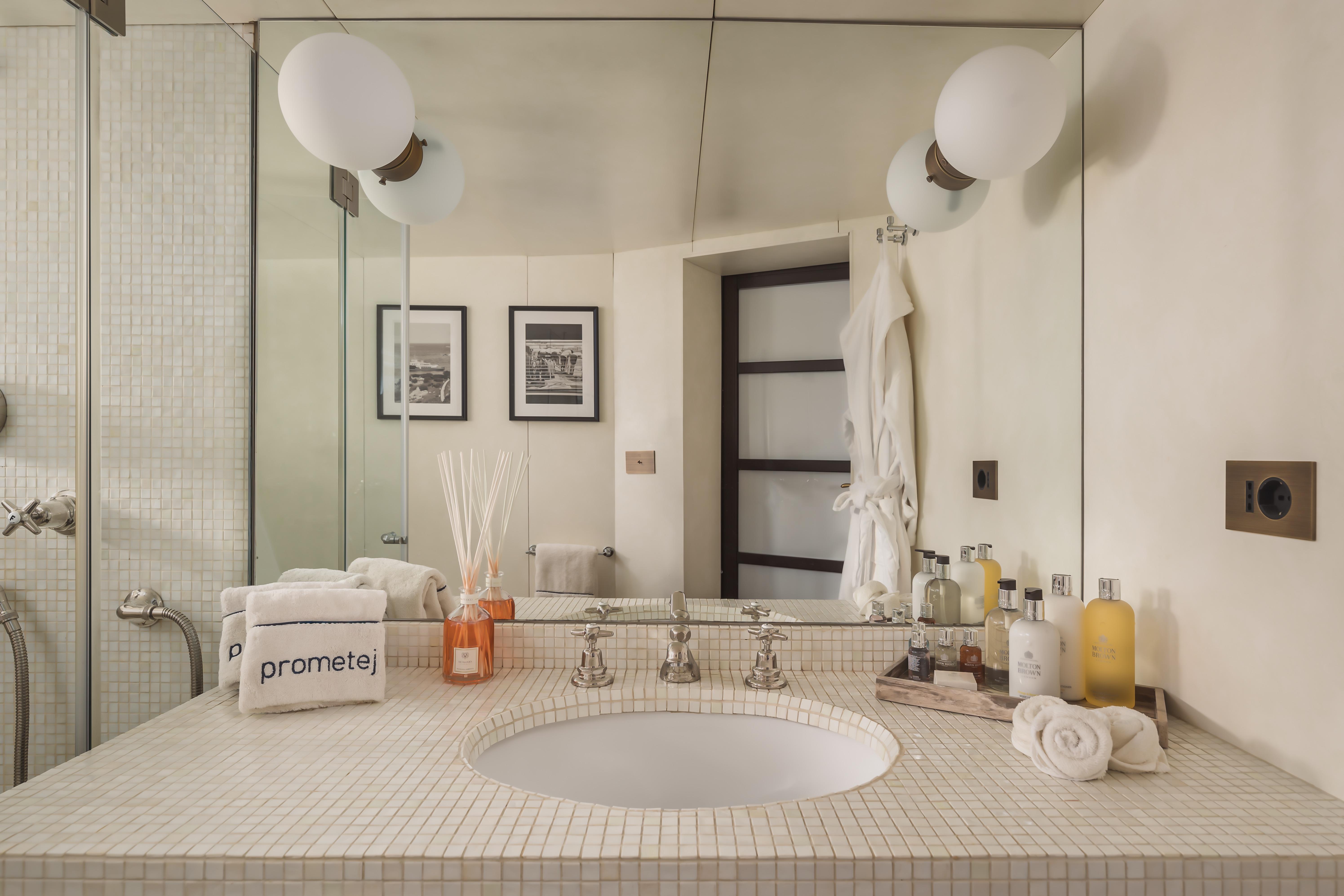 Luxurious bathroom with modern fixtures, elegant toiletries, and soft lighting in a converted 1956 tug.
