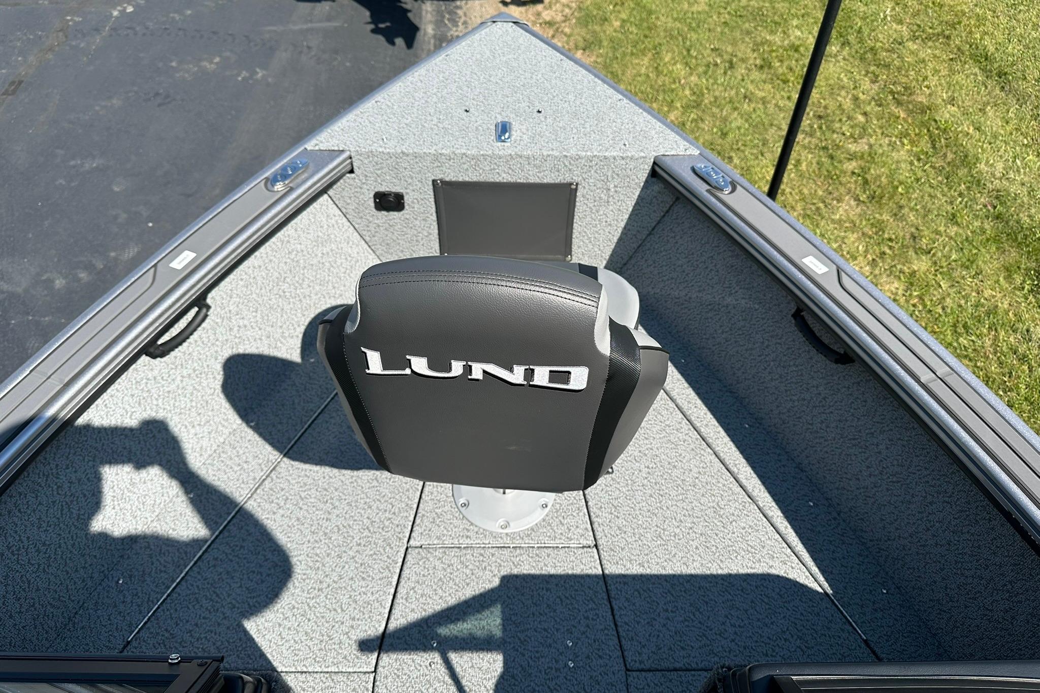 2026 Lund 1875 Fisherman boat interior with branded seat and gray flooring.