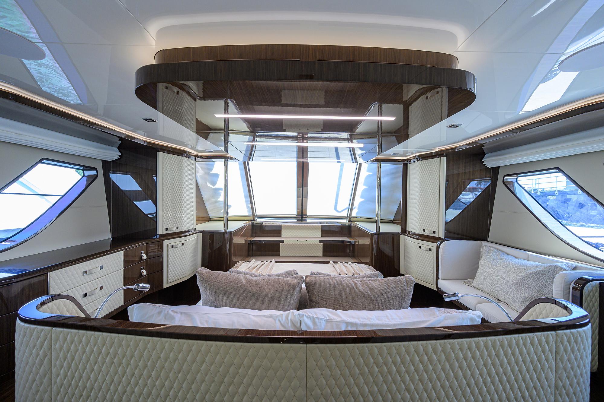 Luxurious interior of 2023 Lazzara LSX 67 yacht with elegant furnishings and panoramic windows.