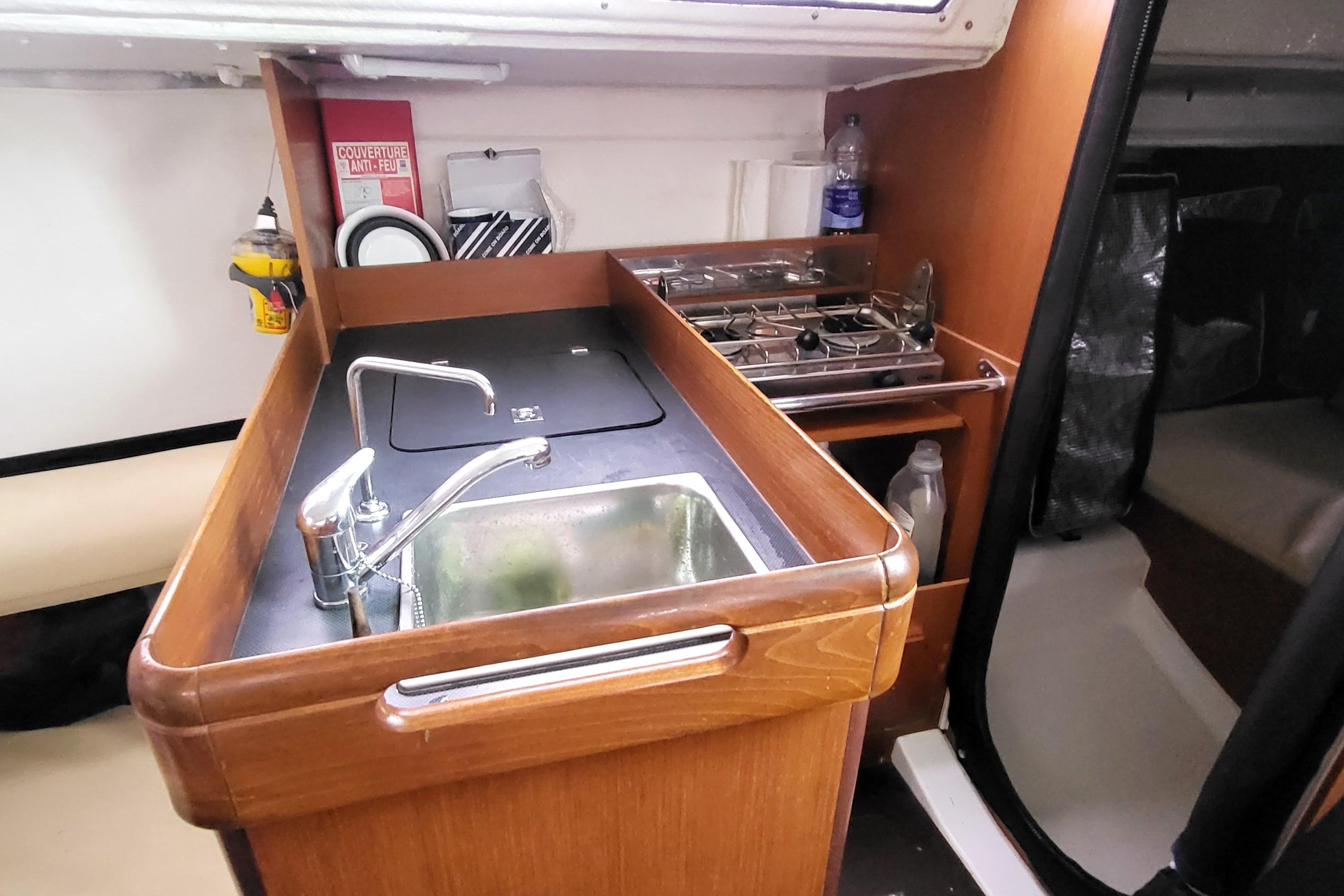 Jeanneau Sun Fast 3200 2011 yacht interior with compact kitchen and sink area.