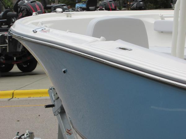 2023 Mako 214 CC boat on trailer, close-up of bow and deck.