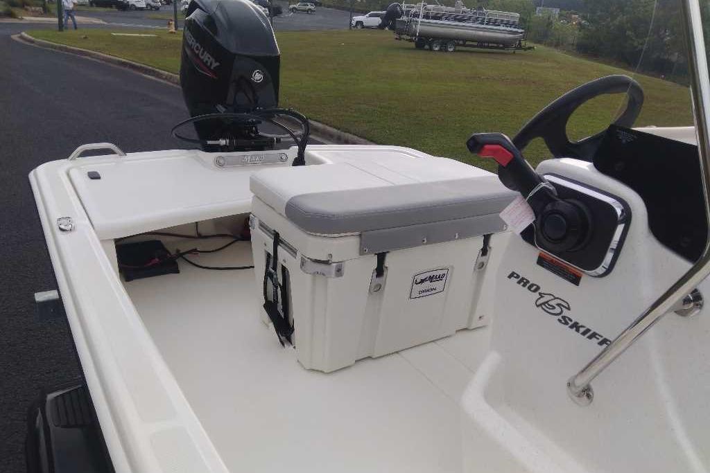 2026 Mako Pro Skiff 15 CC boat interior with steering and cooler.