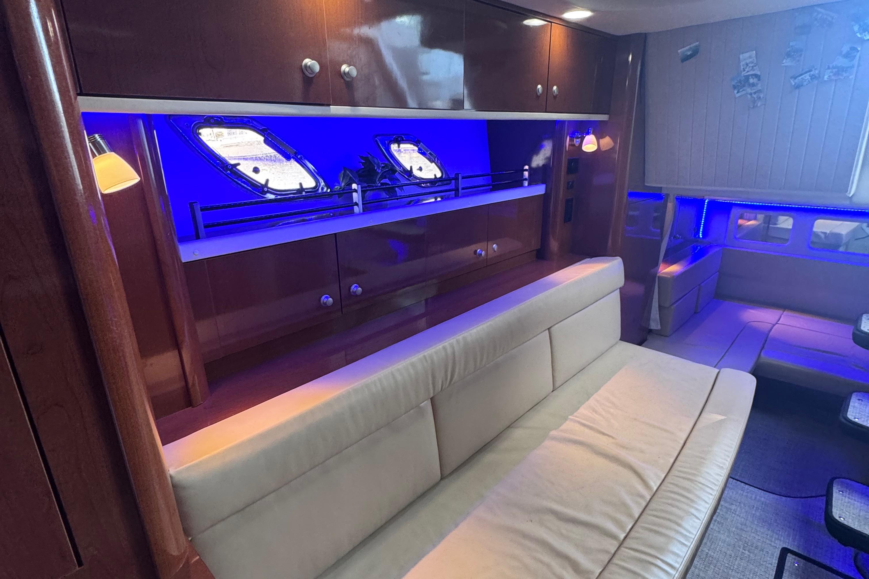Luxurious interior of 2008 Sea Ray 350 Sundancer yacht with blue ambient lighting.
