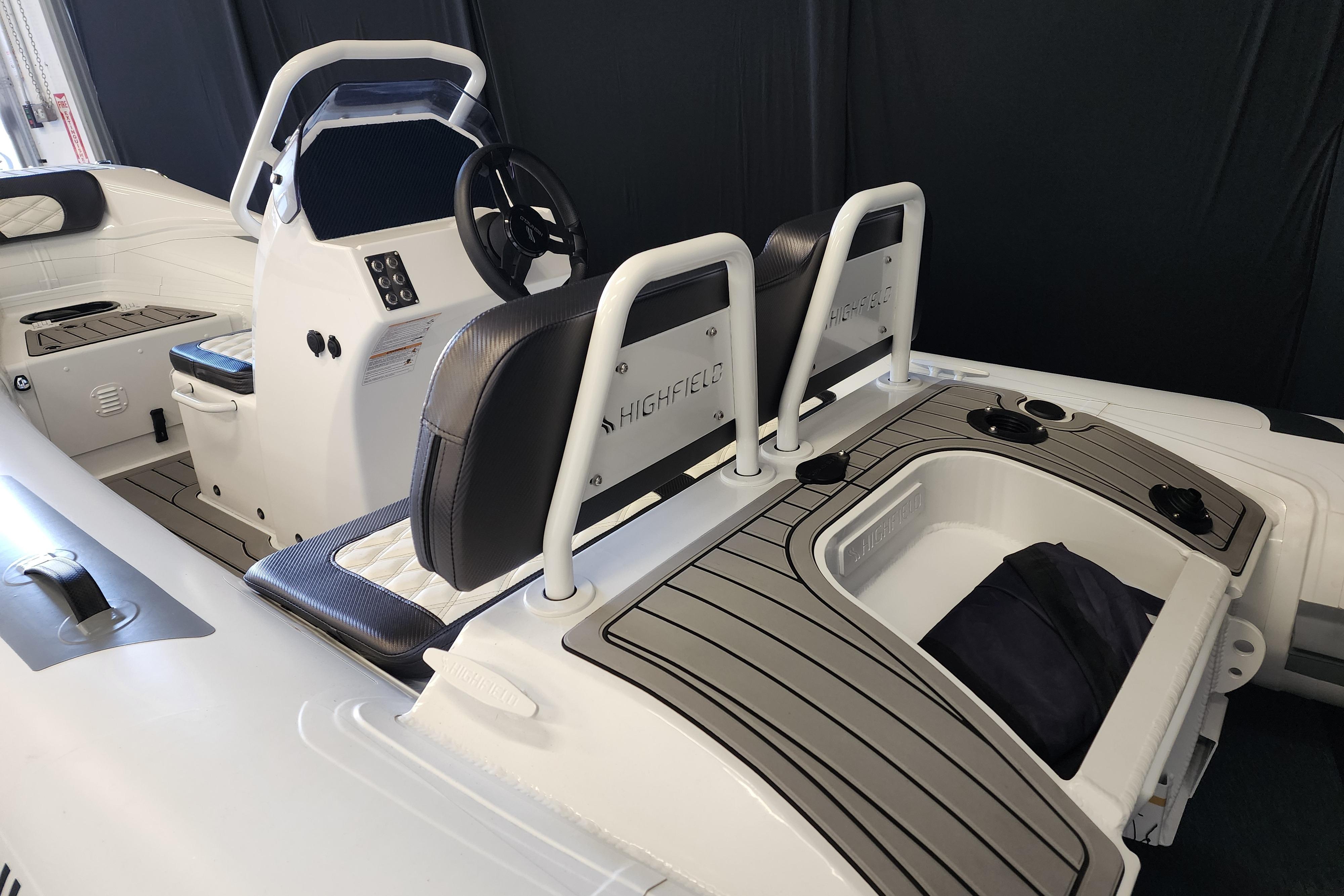 2025 Highfield Sport 390 boat interior with seating and steering console.