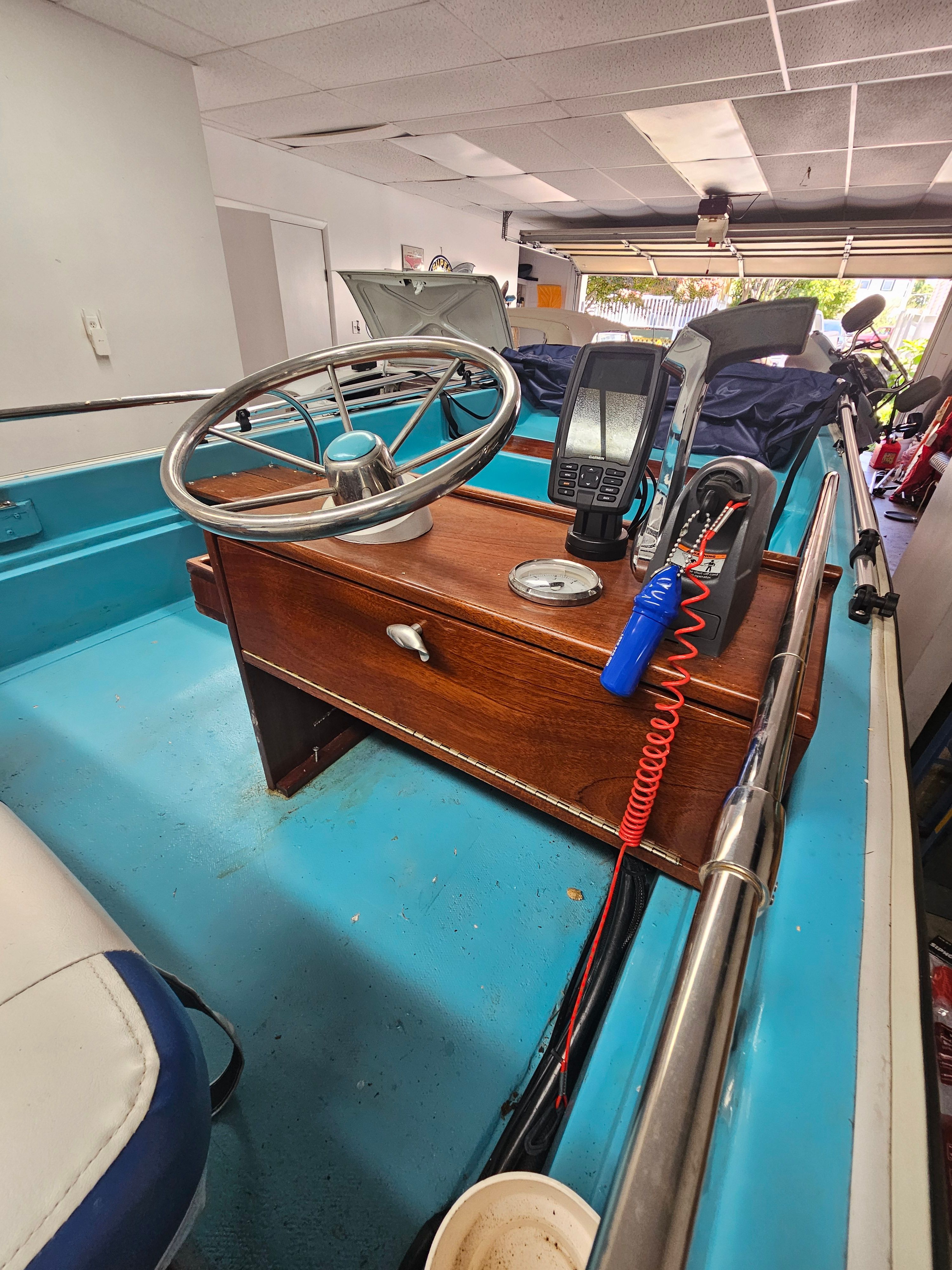Interior view of a 1977 Boston Whaler 14 boat with steering console.