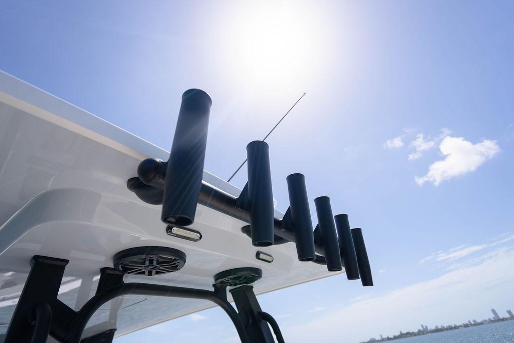 Rooftop rod holders on 2027 Reef Runner 340 boat under sunny sky.