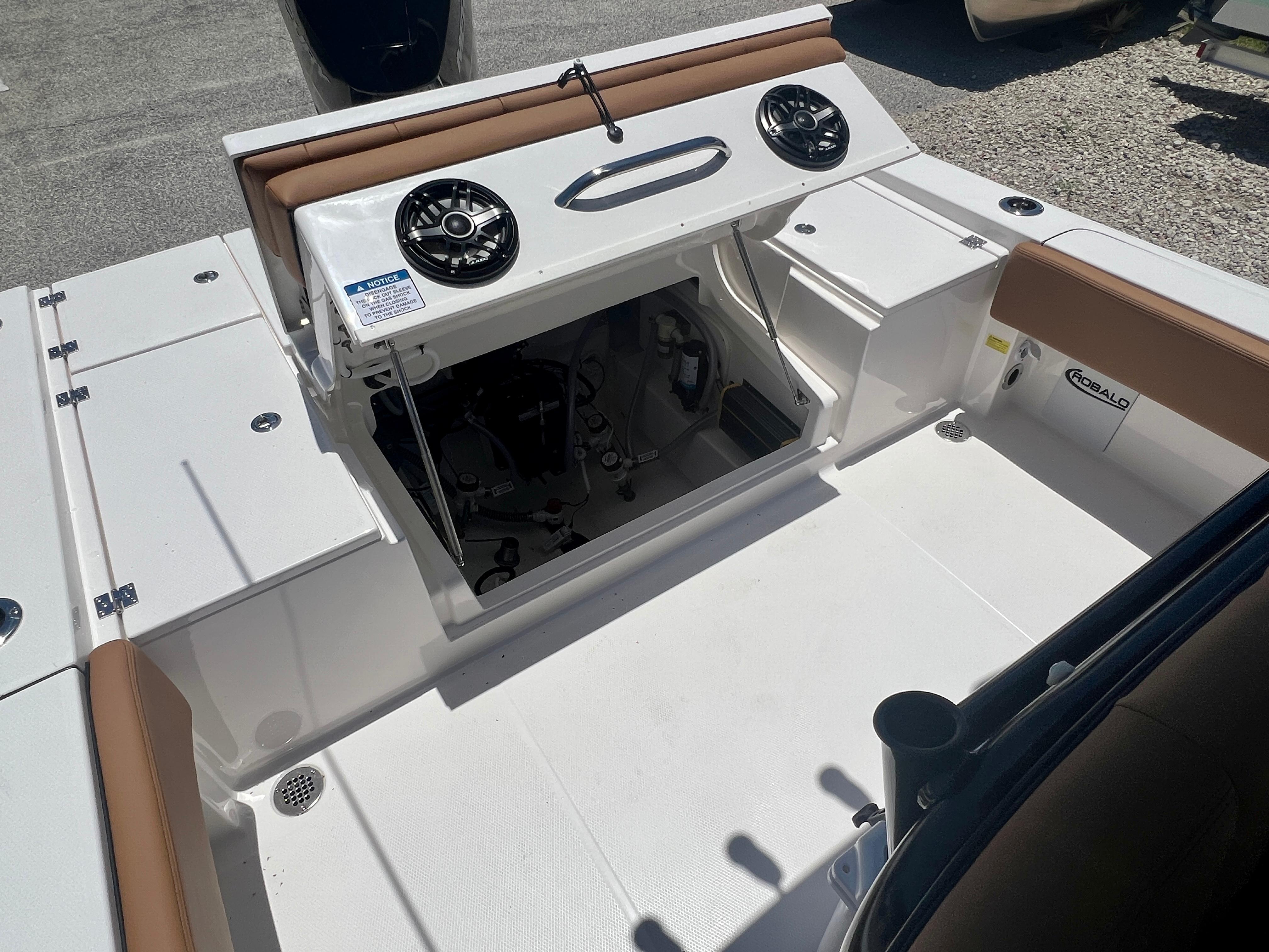 Robalo 266 Cayman 2025 boat with open storage and speakers.