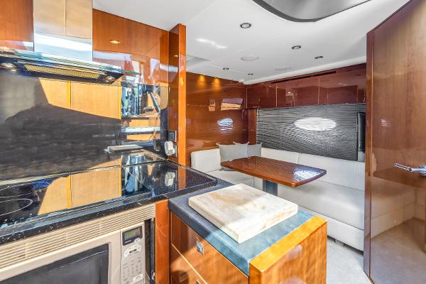 Interior of 2013 Princess V57 yacht with modern kitchen and dining area.