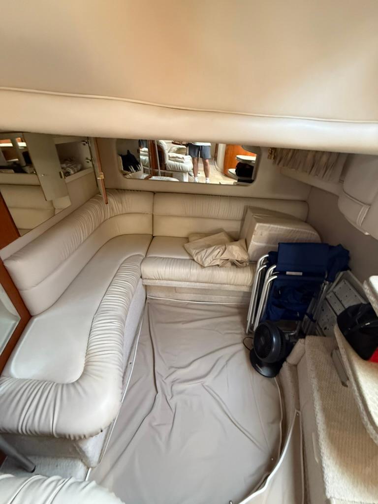 Interior of 2000 Sea Ray 380 Sundancer with cream leather seating and compact design.
