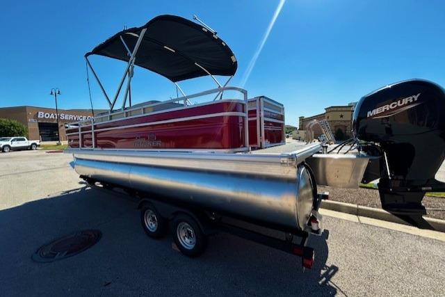 2026 Sun Tracker Fishin' Barge 22 DLX pontoon boat with Mercury engine on trailer.