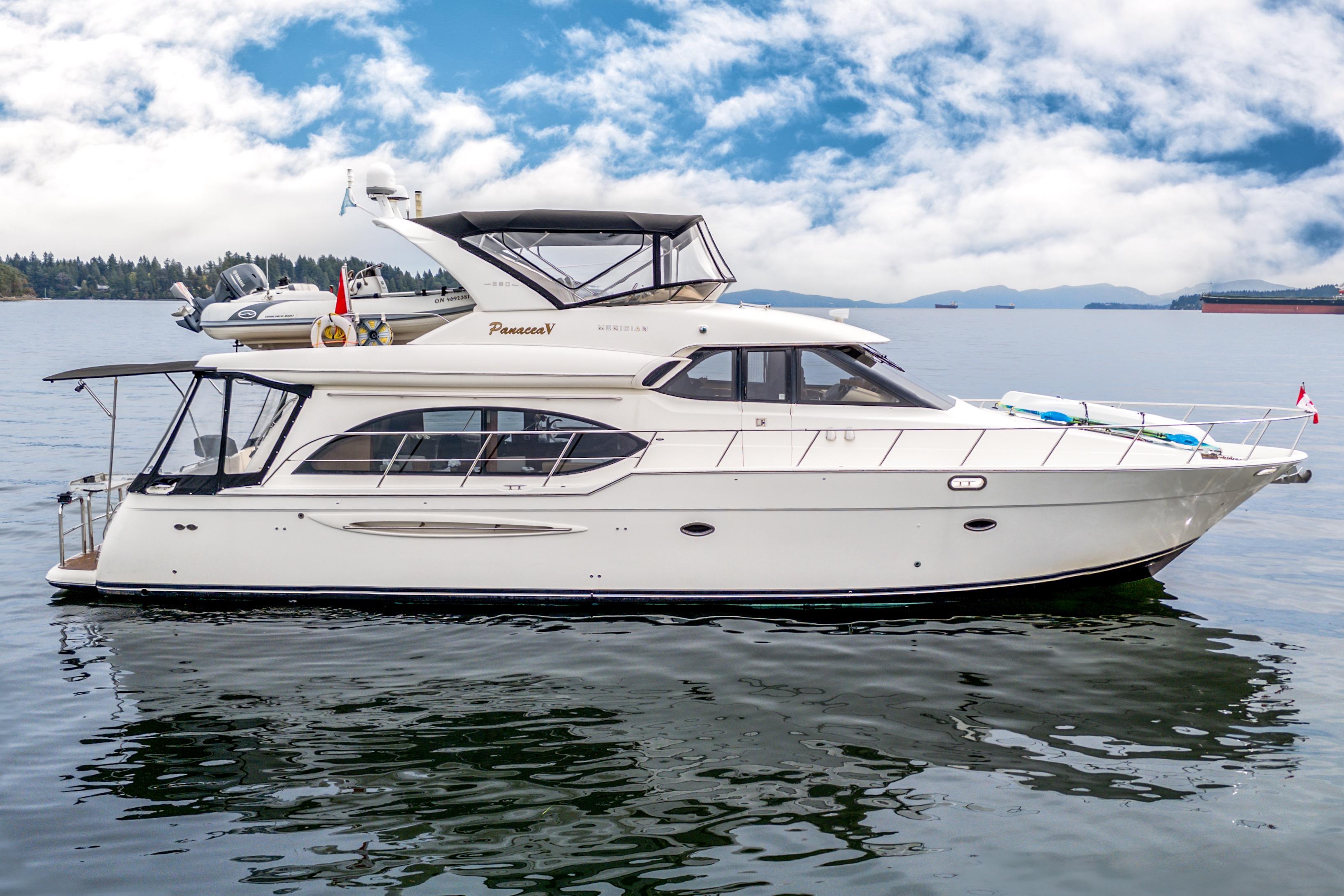 2007 Meridian 580 Pilothouse yacht on calm water under a partly cloudy sky.