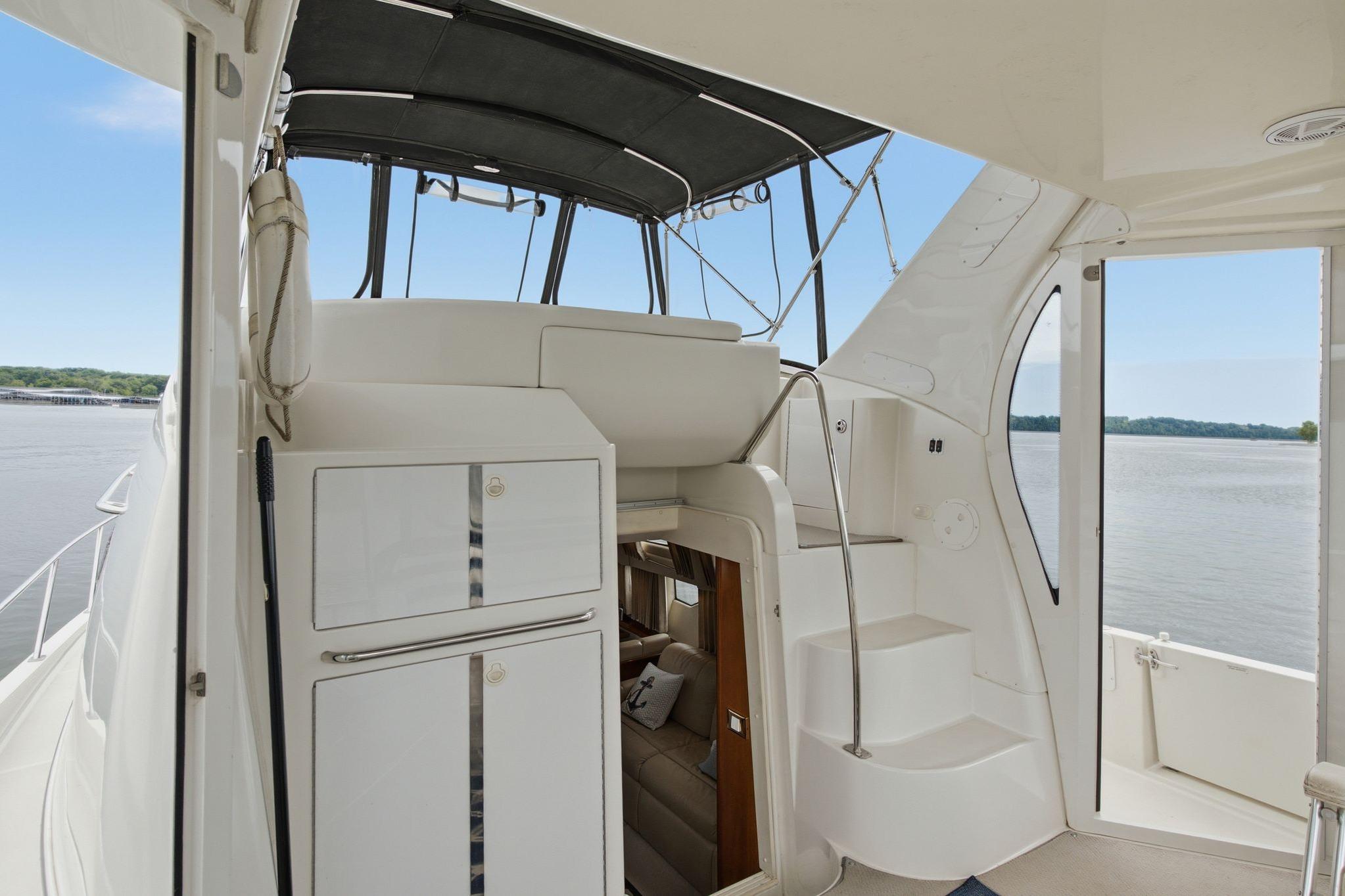 2005 Carver 39 Motor Yacht interior with stairs and water view.