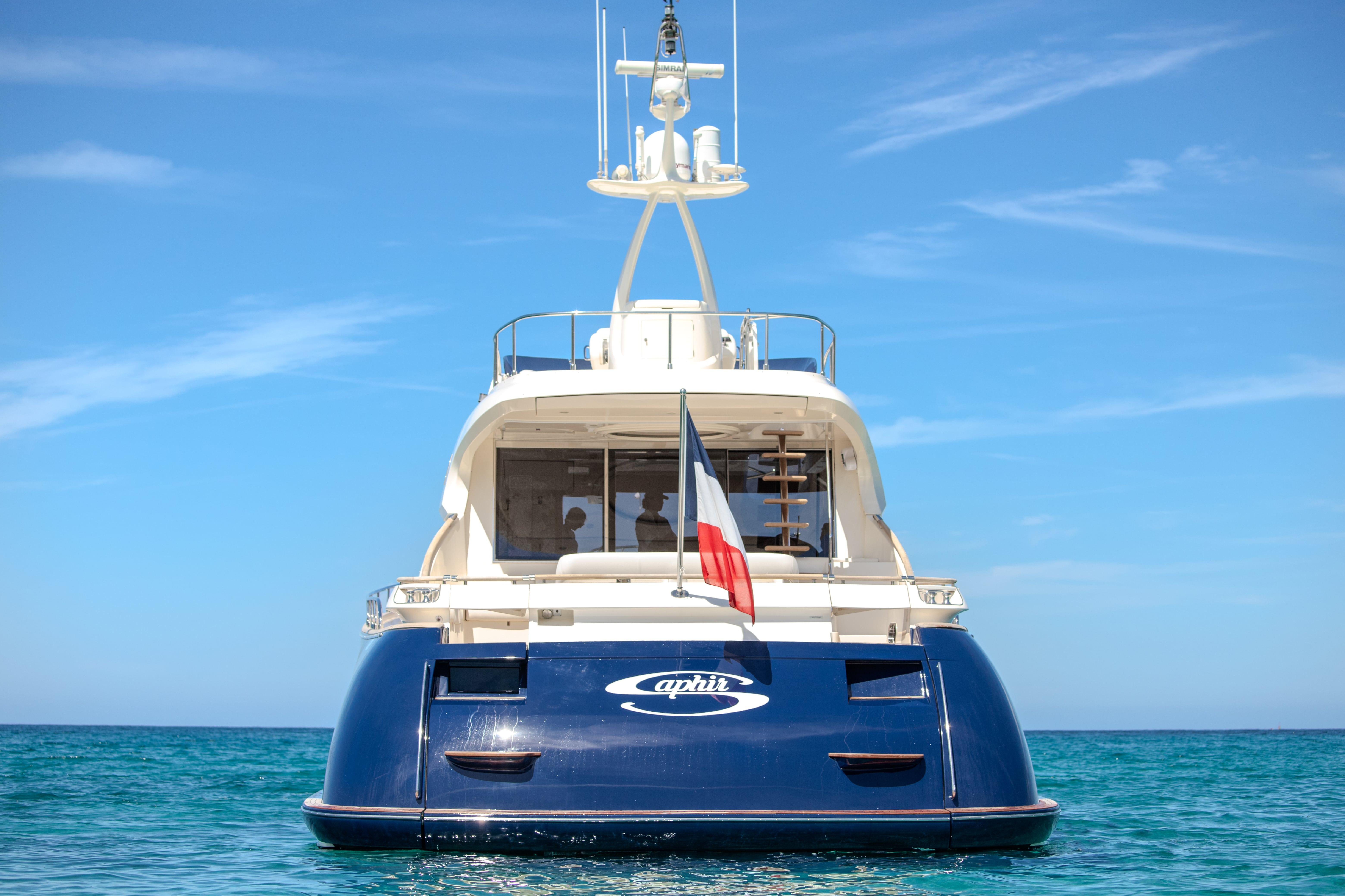 Luxury 2005 Mochi Craft 74' Dolphin yacht on clear blue sea.