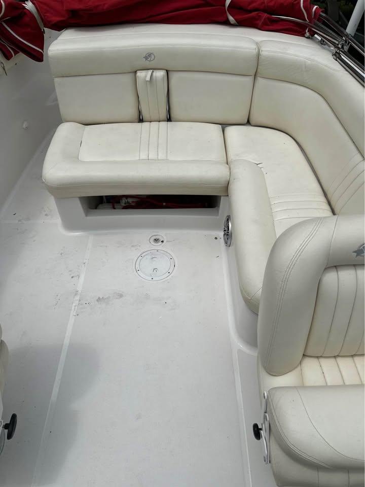 2001 Chris-Craft Launch 22 boat interior with white leather seating and red cover.