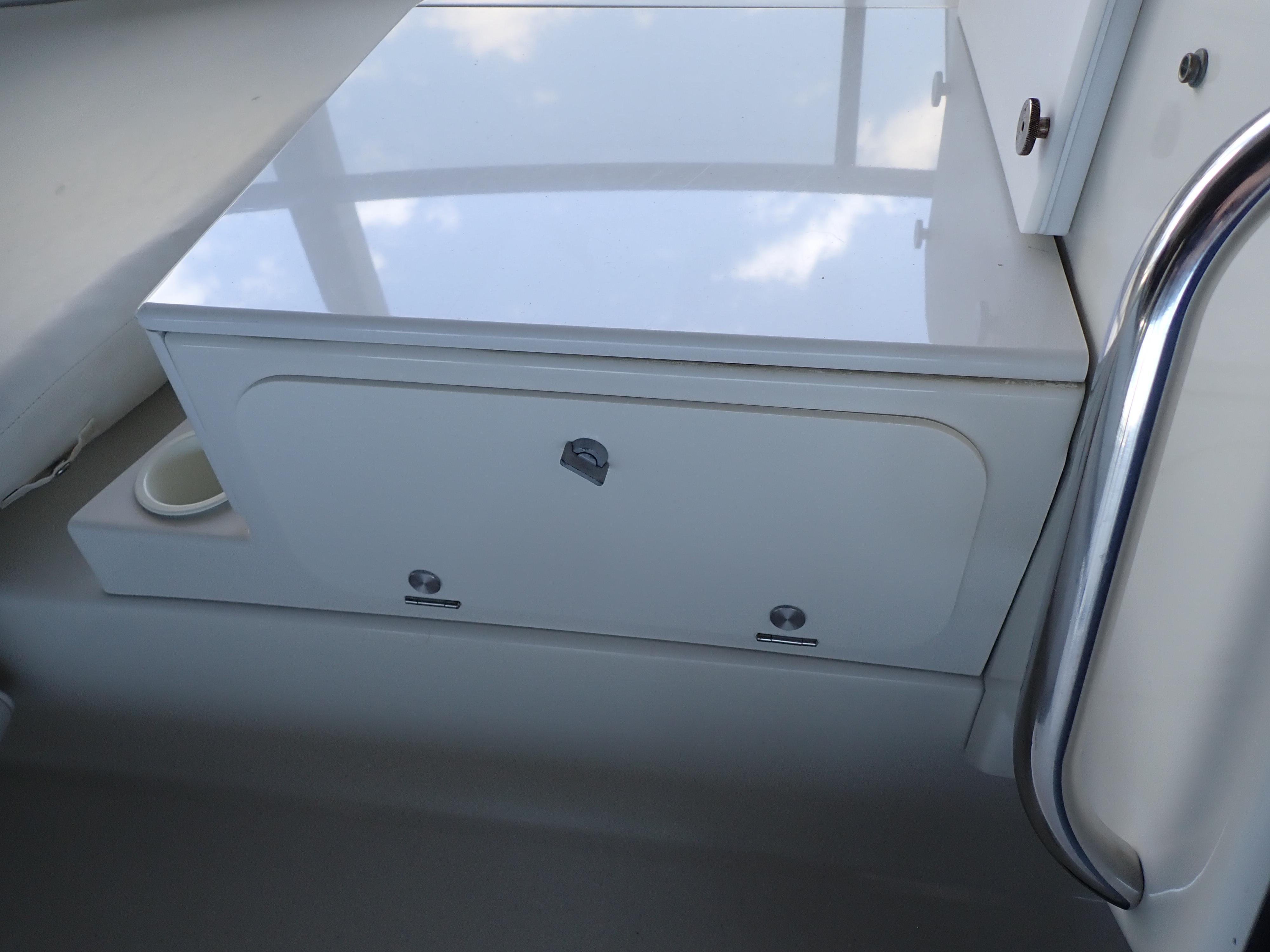 1996 Carver 370 Voyager interior storage compartment with sleek white finish and metal handle.