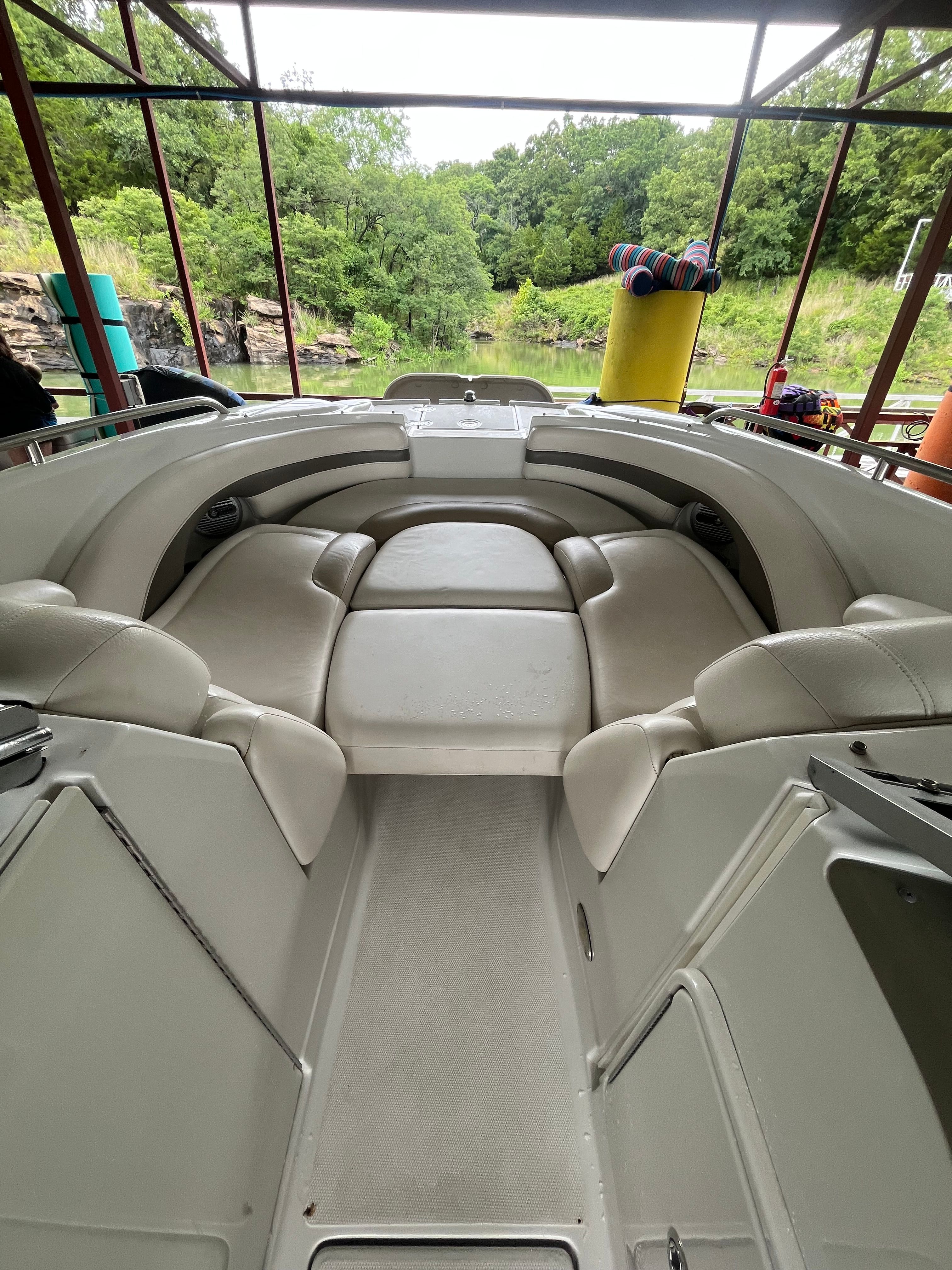 The image shows the cockpit of a 2008 Crownline 252EX boat with beige seating.