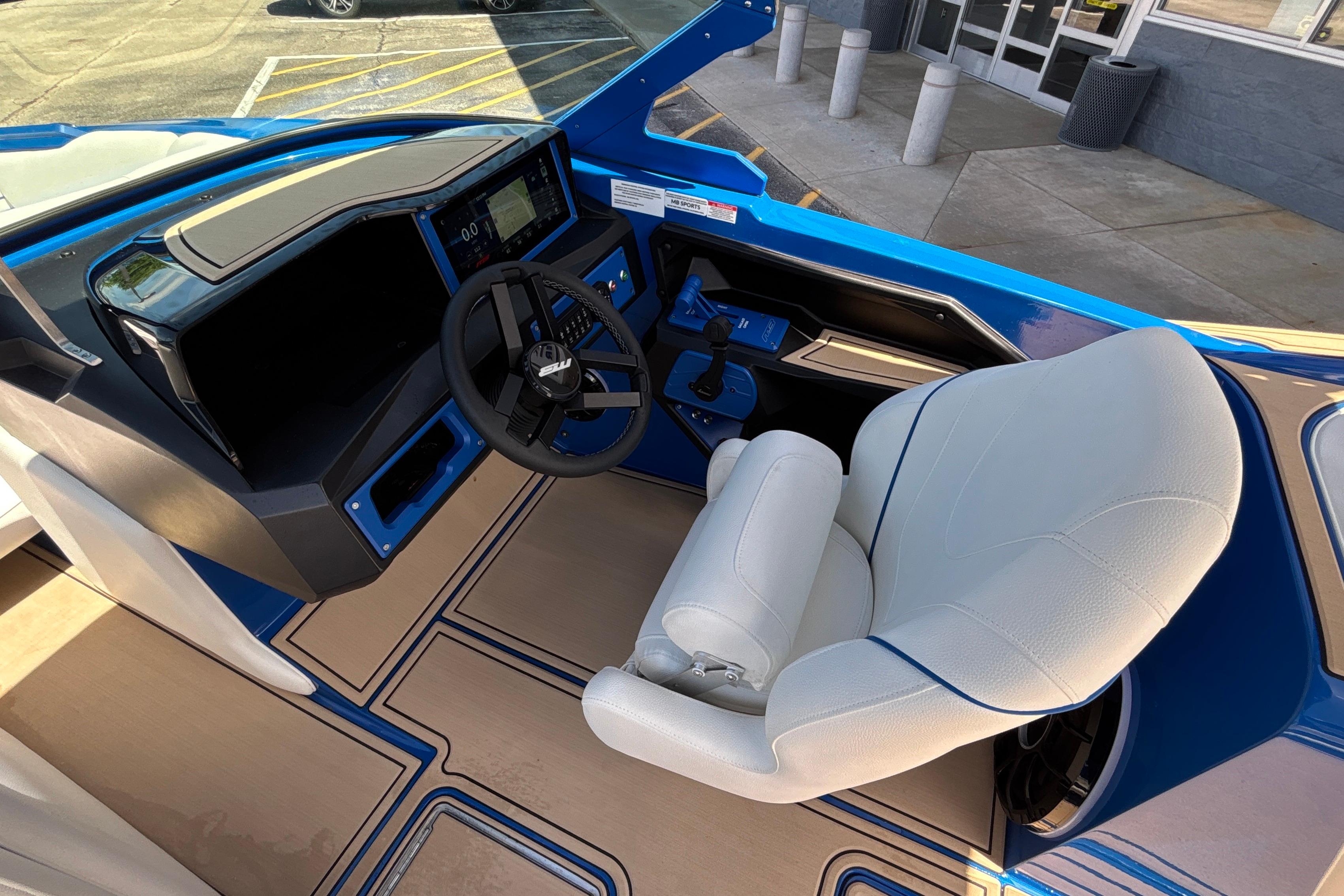 Interior of 2026 MB B52 23 Alpha boat with modern dashboard and white captain's chair.