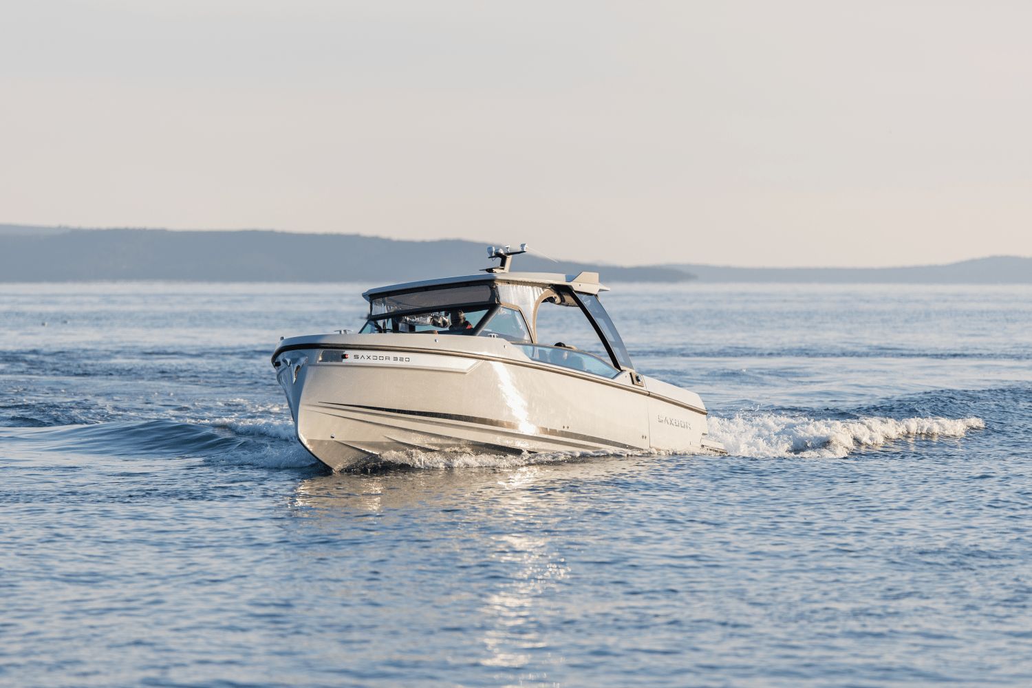 Saxdor SX320 GTO from 2027 cruising on calm water with gentle waves.