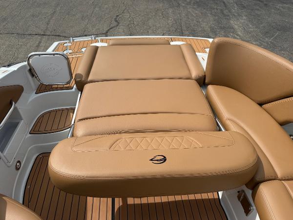 2025 Crownline 290 SS boat with tan leather seating and teak flooring.