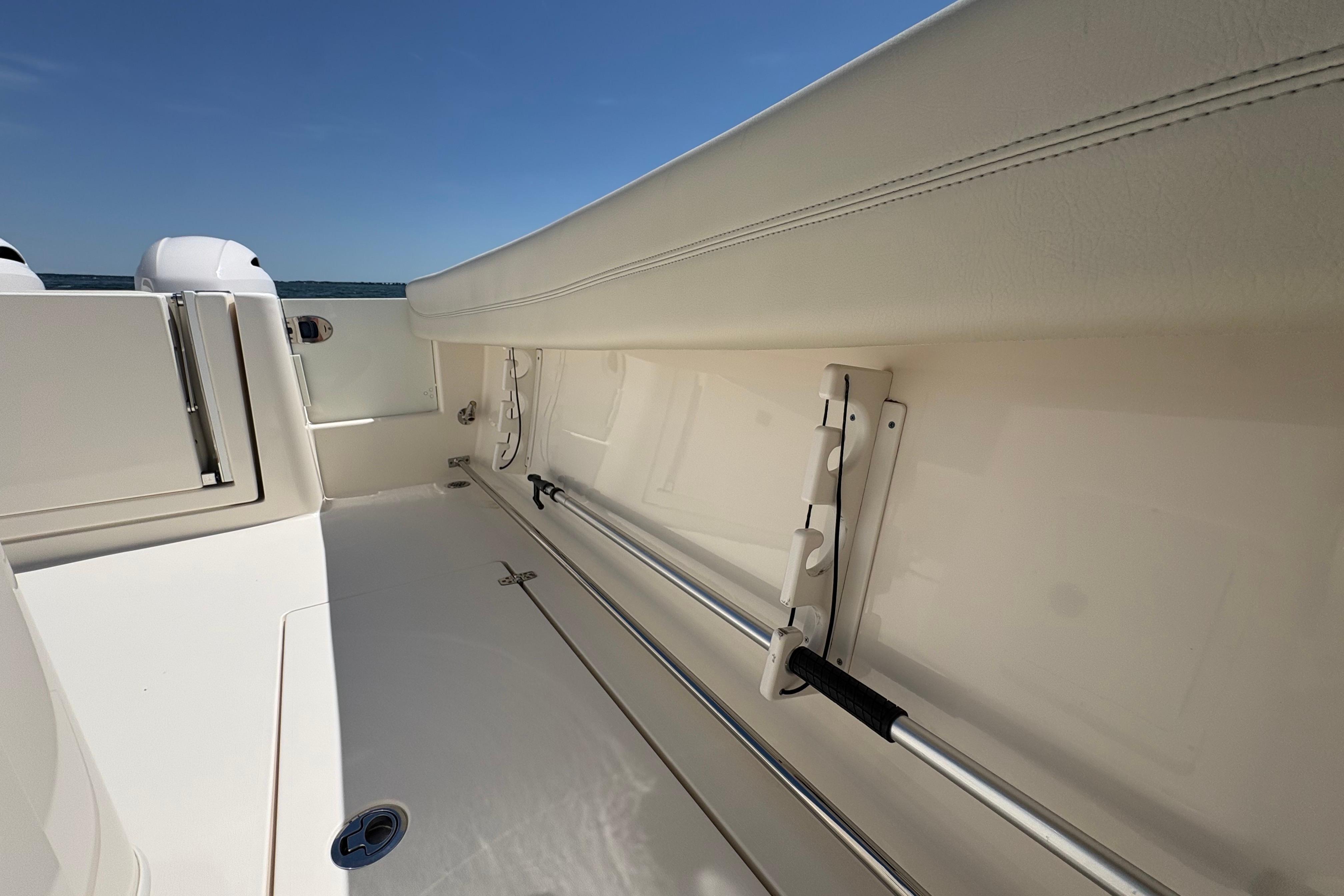 2018 Cobia 277 Center Console boat interior with rod holders and sleek design.