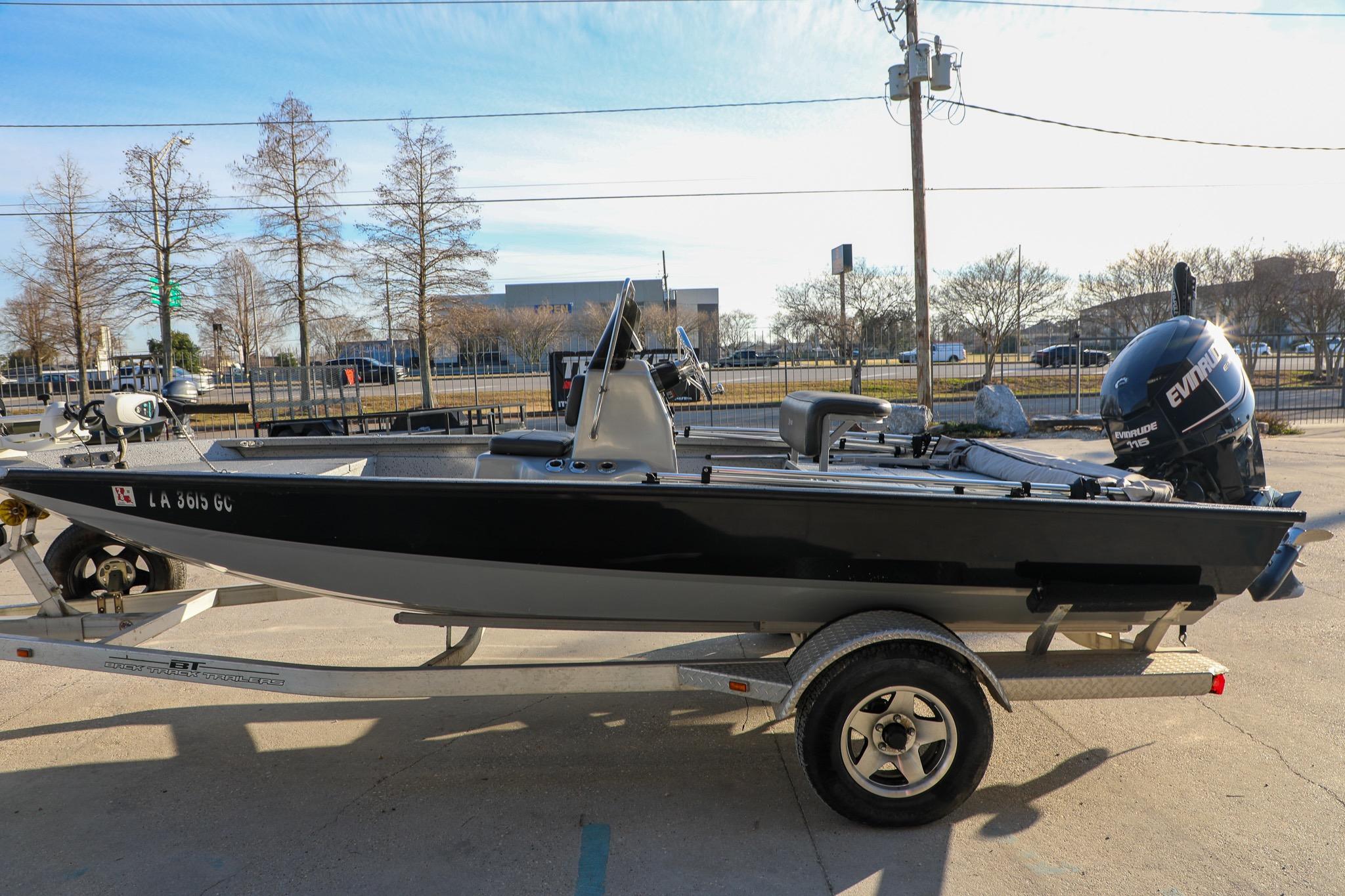 2019 Express 18 boat on trailer with Evinrude motor, parked outdoors.