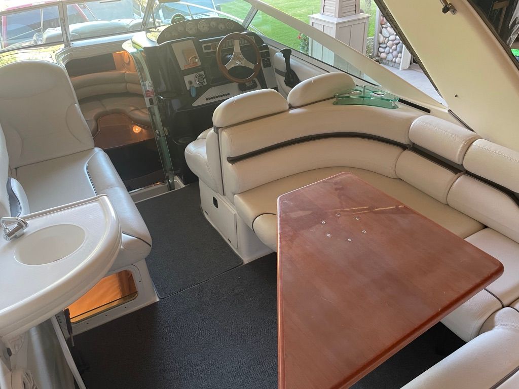 Interior of a 2007 Doral Monticello with cream seats and a wooden table.