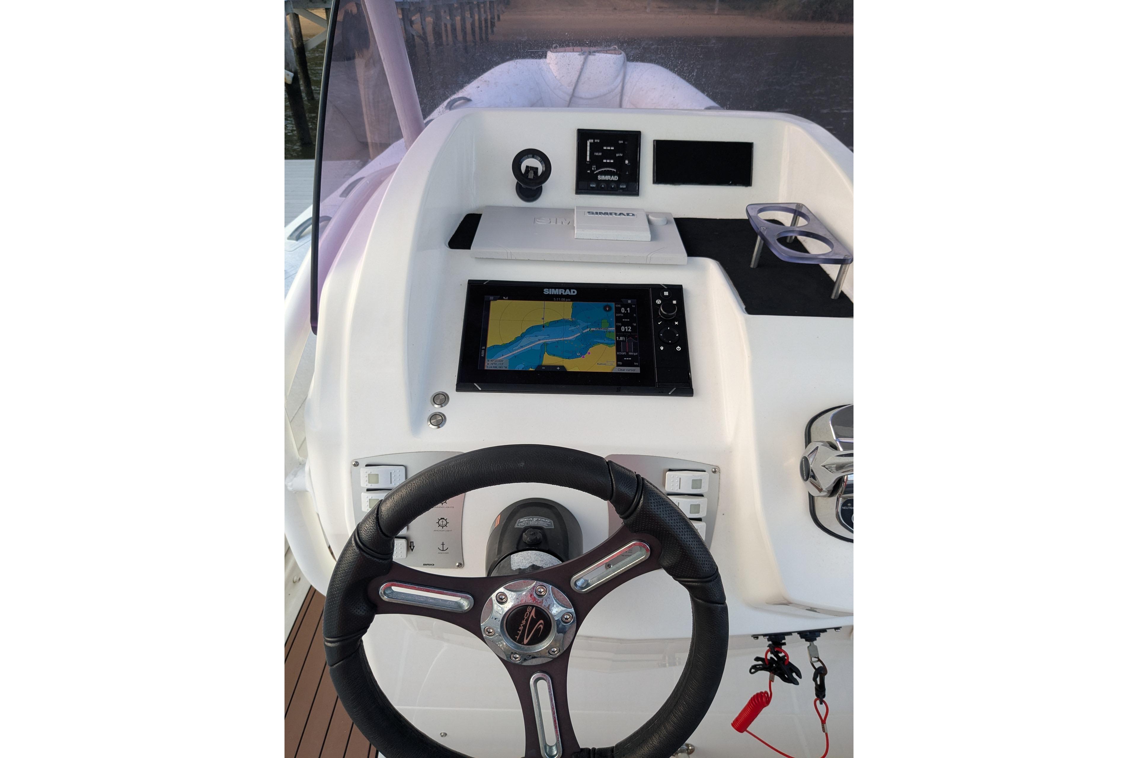 Steering console of 2016 Brig E780 boat with navigation display and controls.