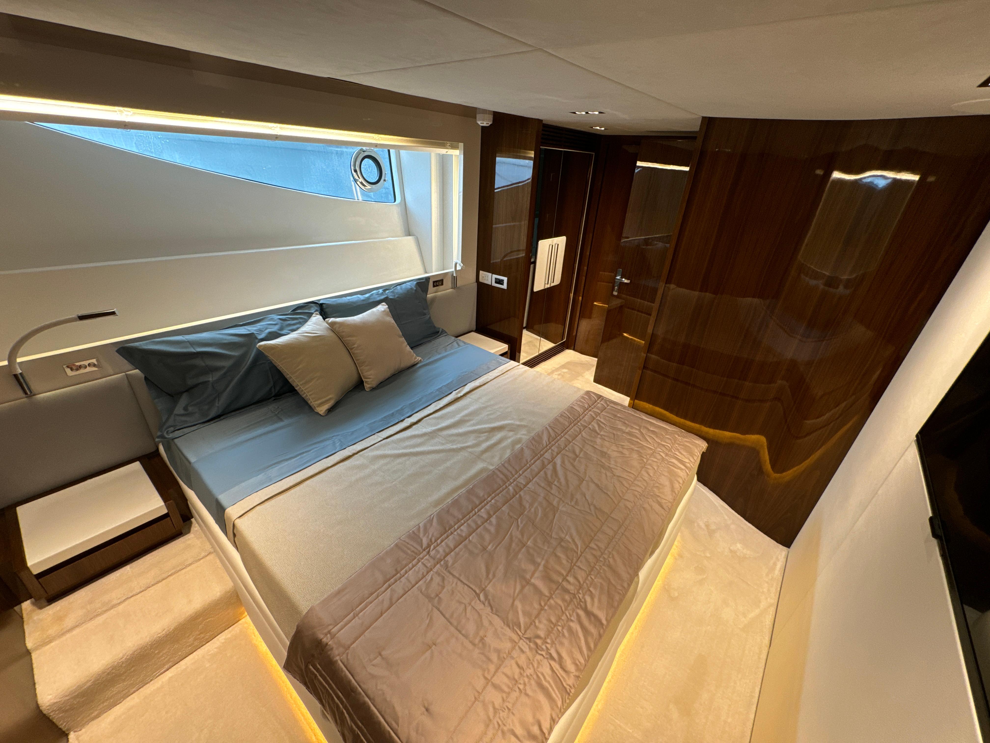 Luxurious bedroom interior of 2020 PerMare Amer F100 yacht with modern design.