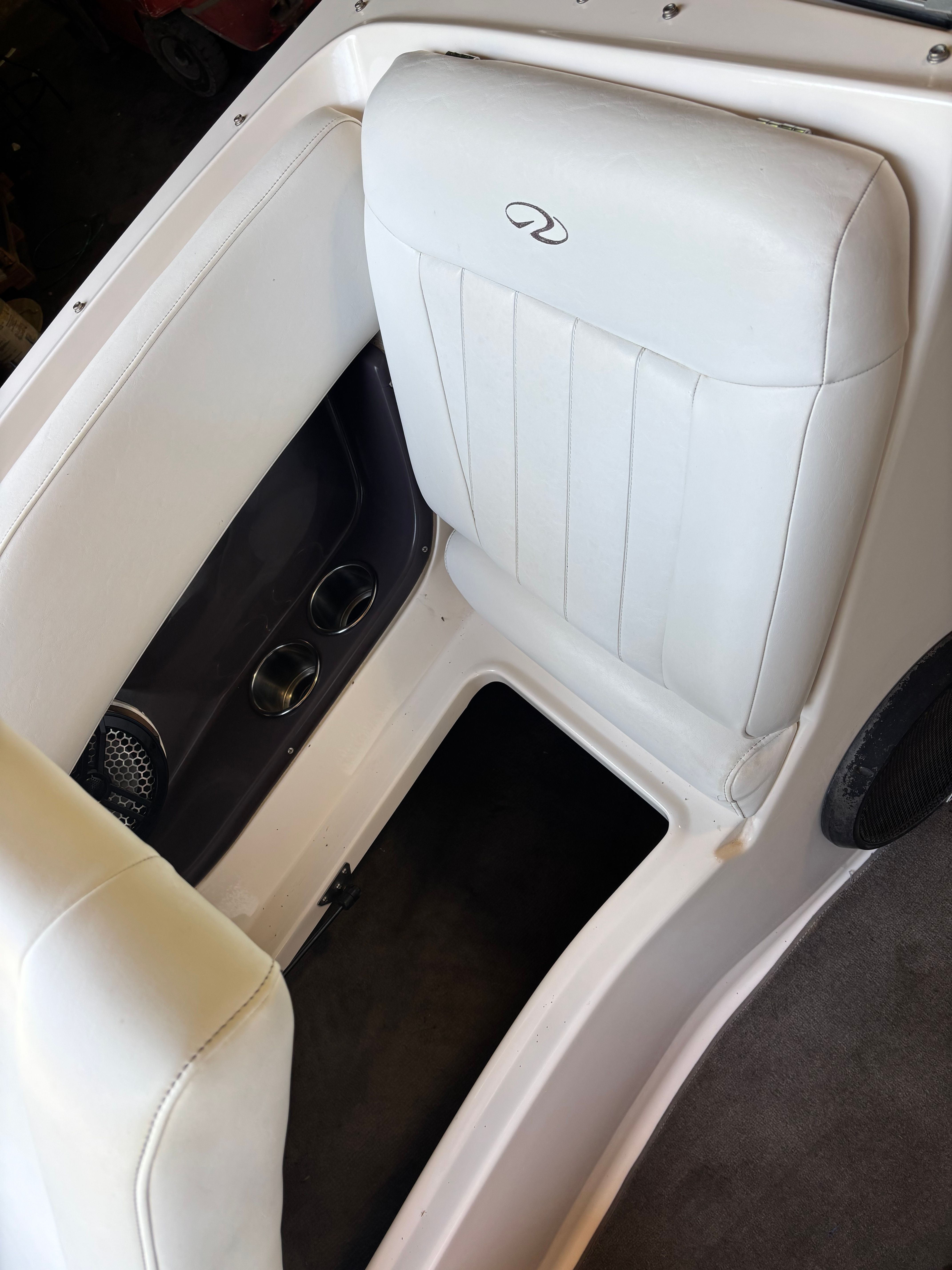 Interior view of a white seat with cup holders in a 2006 Regal 2200 Bowrider.