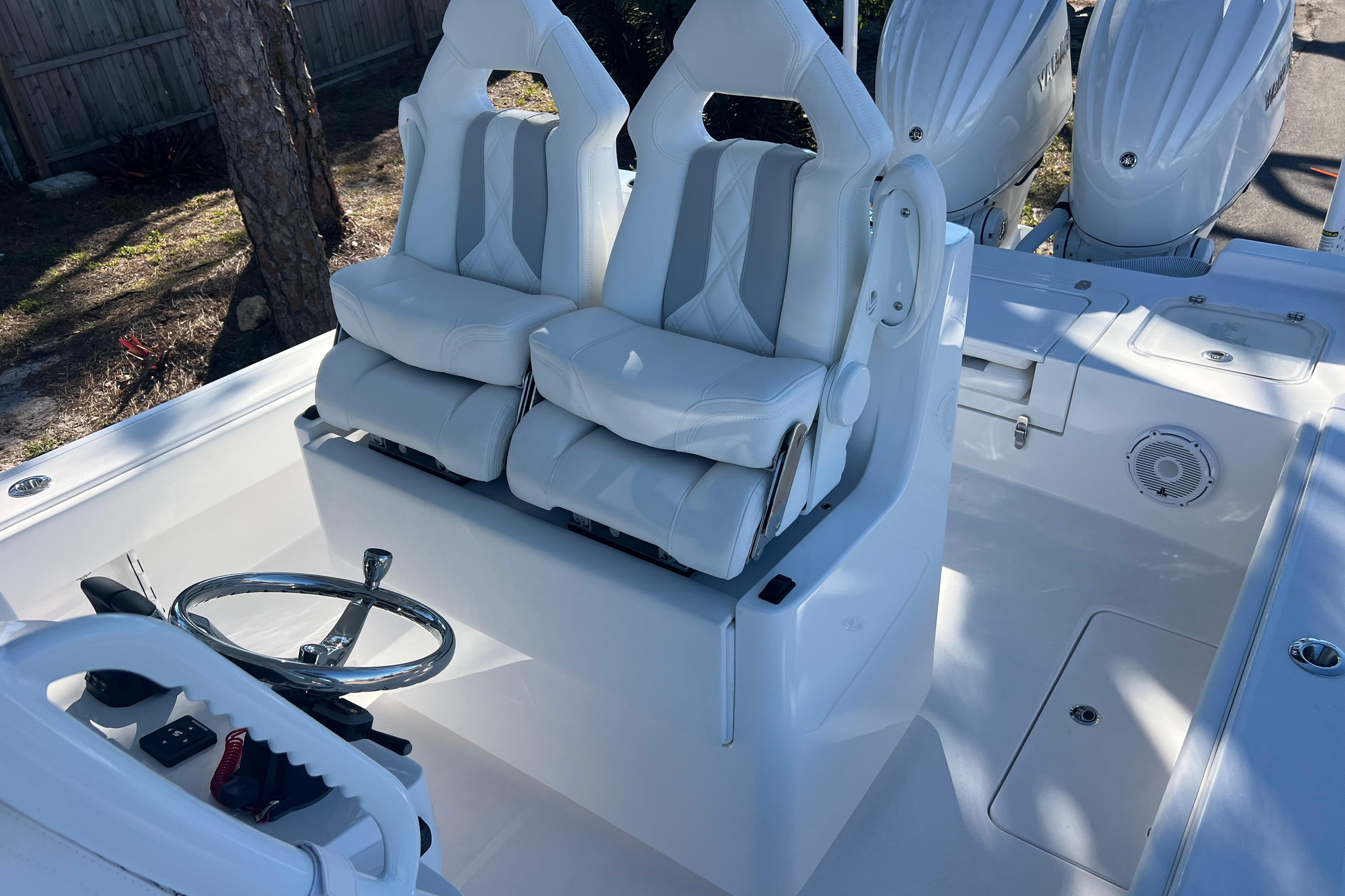 2026 Contender 29 Bay boat interior with dual white seats and steering wheel.