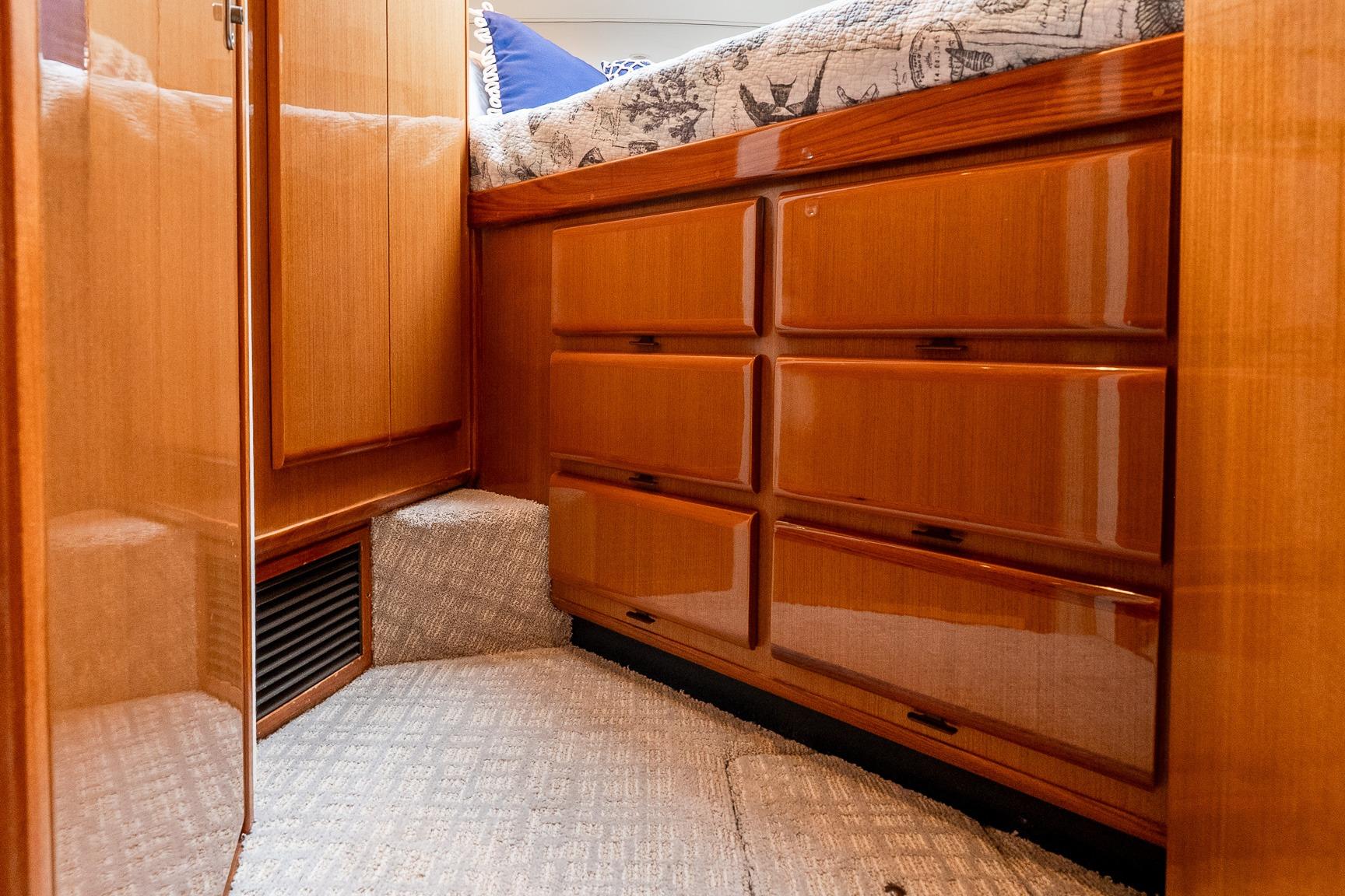 Interior of a 2000 Viking 50' Convertible yacht with wooden cabinetry and carpeted flooring.
