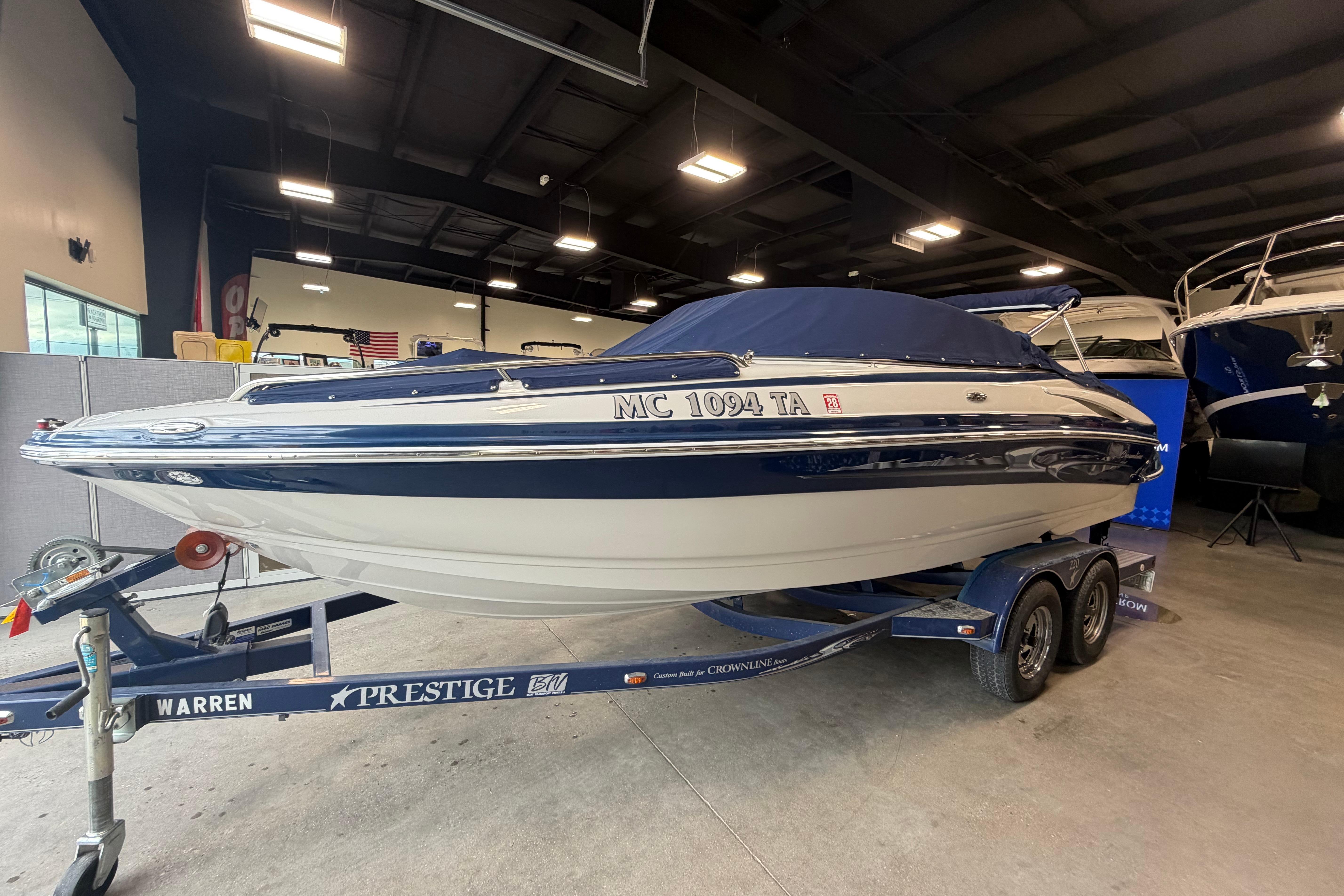 2008 Crownline 220 LS boat on trailer in indoor showroom.