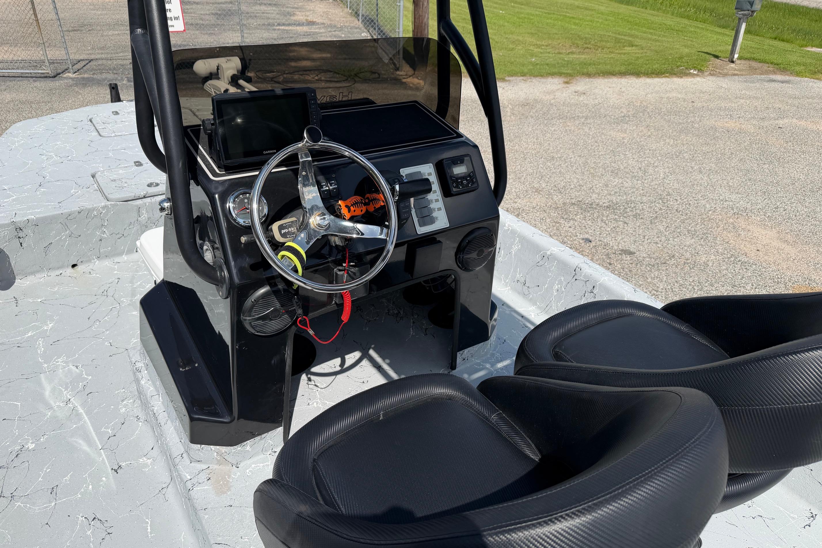 2023 Haynie 23 Super Cat boat interior with steering wheel and seats.
