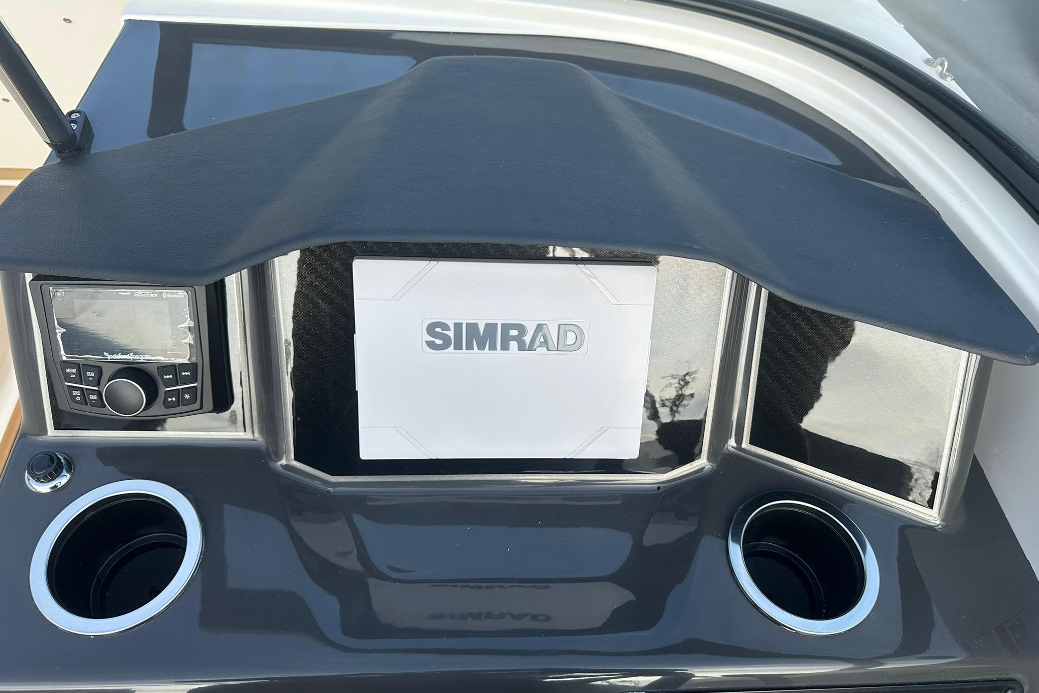 Dashboard of 2026 Bayliner VR6 Bowrider OB with Simrad display and cup holders.
