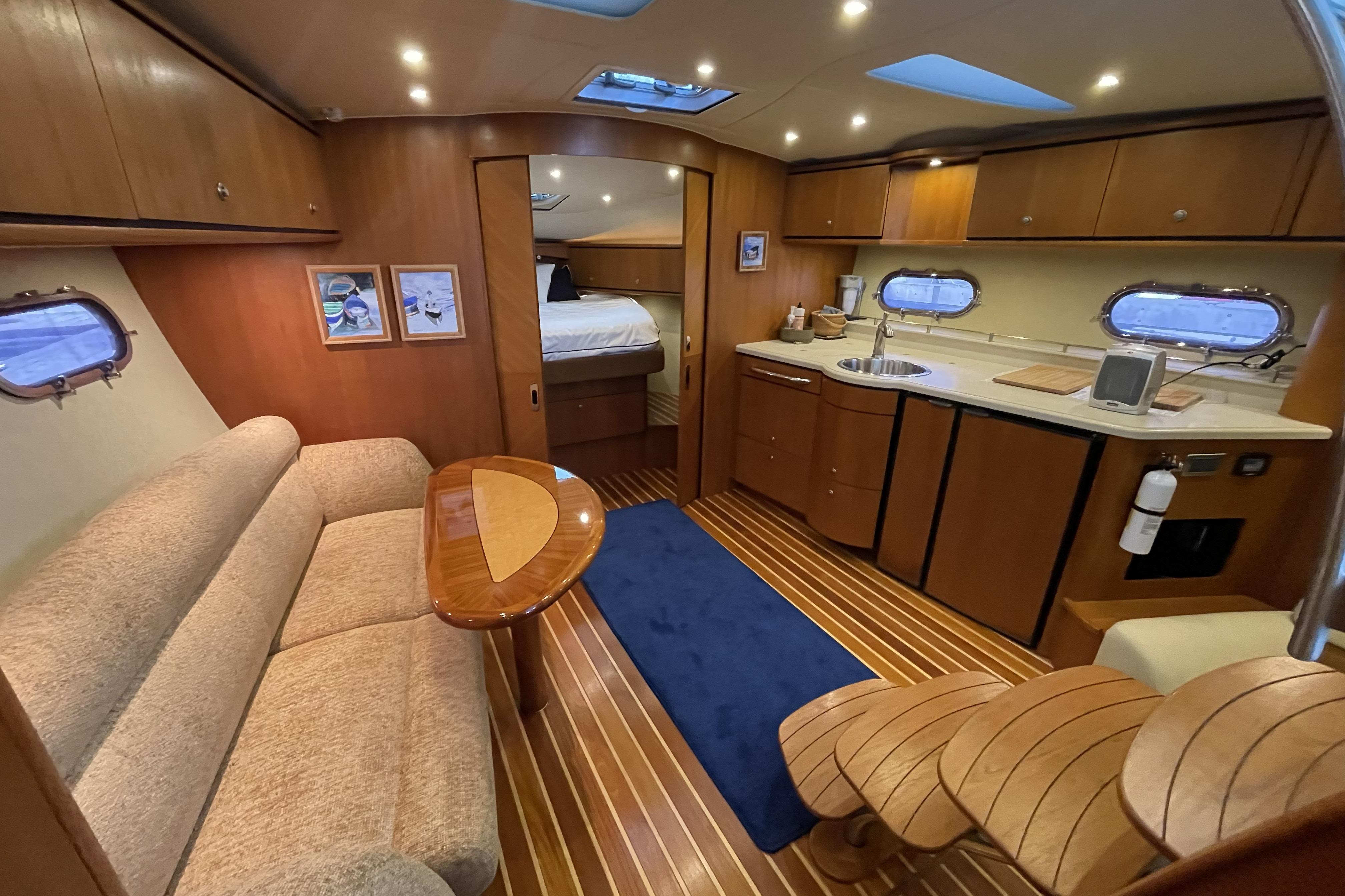 Luxurious interior of 2007 Tiara Yachts 3900 Sovran with cozy seating and modern kitchen.