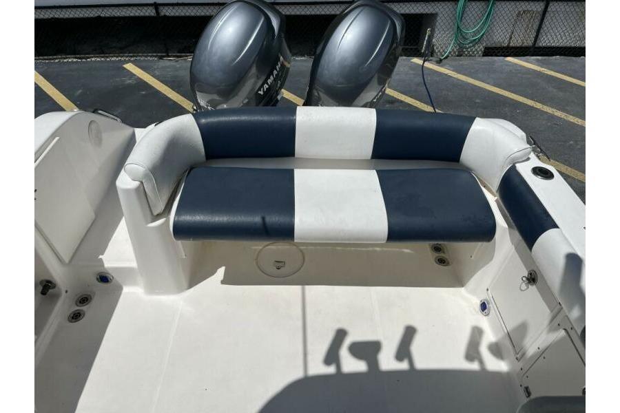 2006 Century 2400 Walk-Around boat interior with striped seating and dual Yamaha engines.
