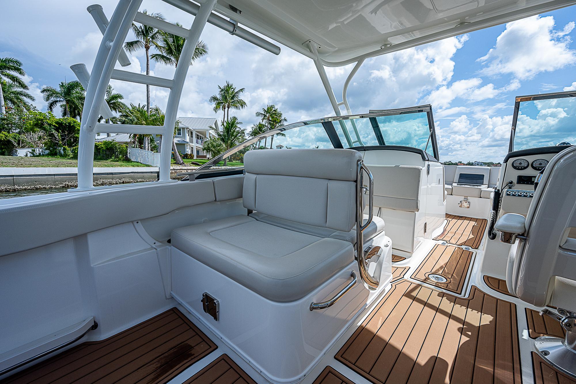 2018 Boston Whaler 270 Vantage interior with seating, teak flooring, and clear skies.