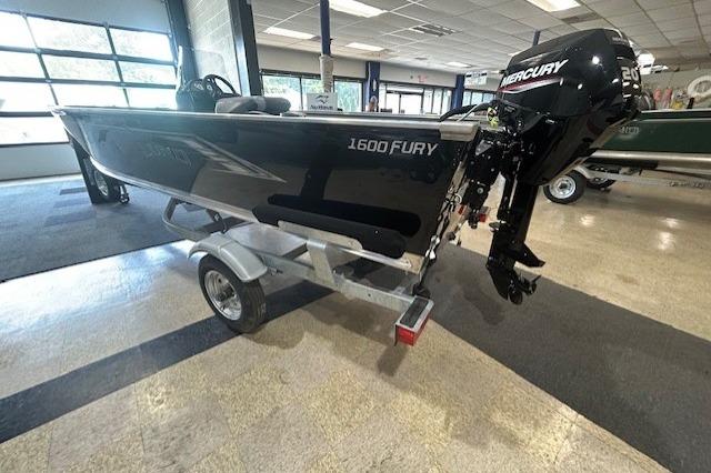 2027 Lund 1600 Fury SS boat with Mercury engine on display indoors.