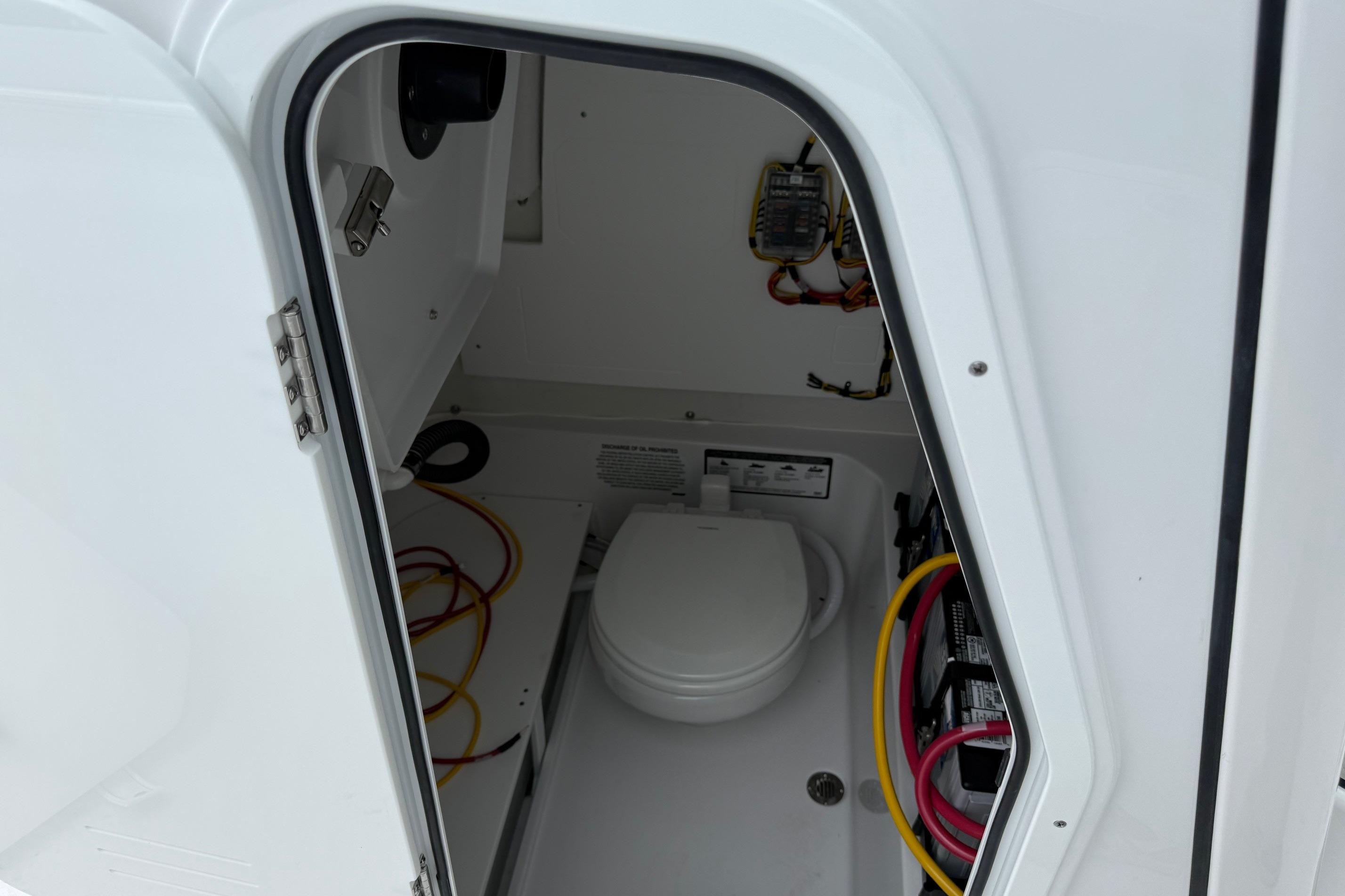 2026 Sportsman Heritage 231 Center Console boat interior with toilet and wiring.