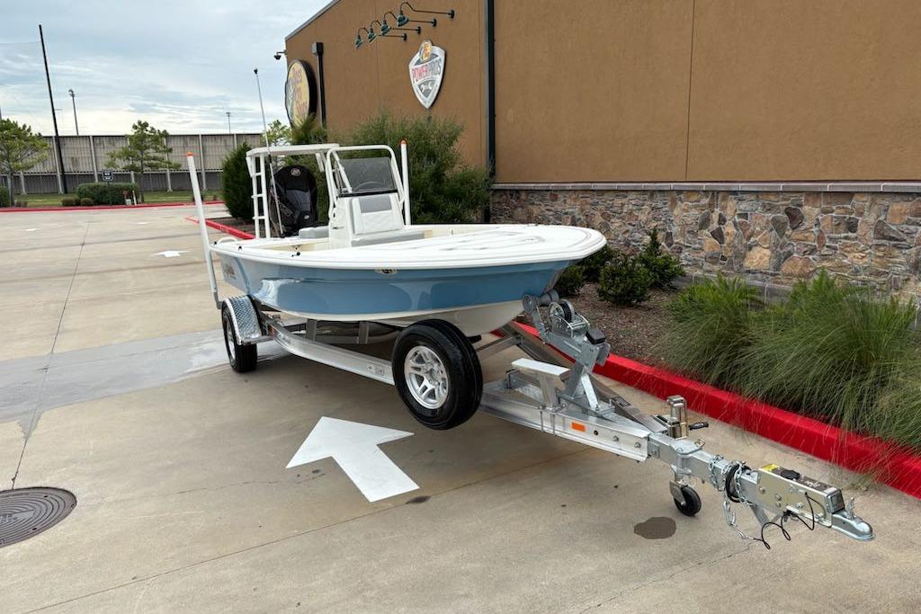2026 Mako 18 Pro Skiff boat on trailer, parked outdoors.