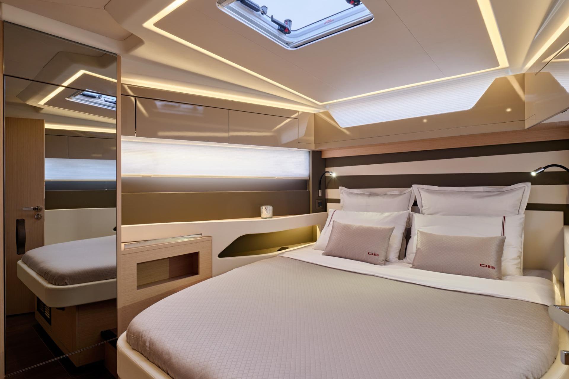 Luxurious cabin interior of 2027 Jeanneau DB/43 OB yacht with modern lighting.