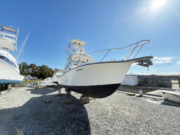 2001 Albemarle 280 Express Sport Fisherman boat on dry dock under clear blue sky.