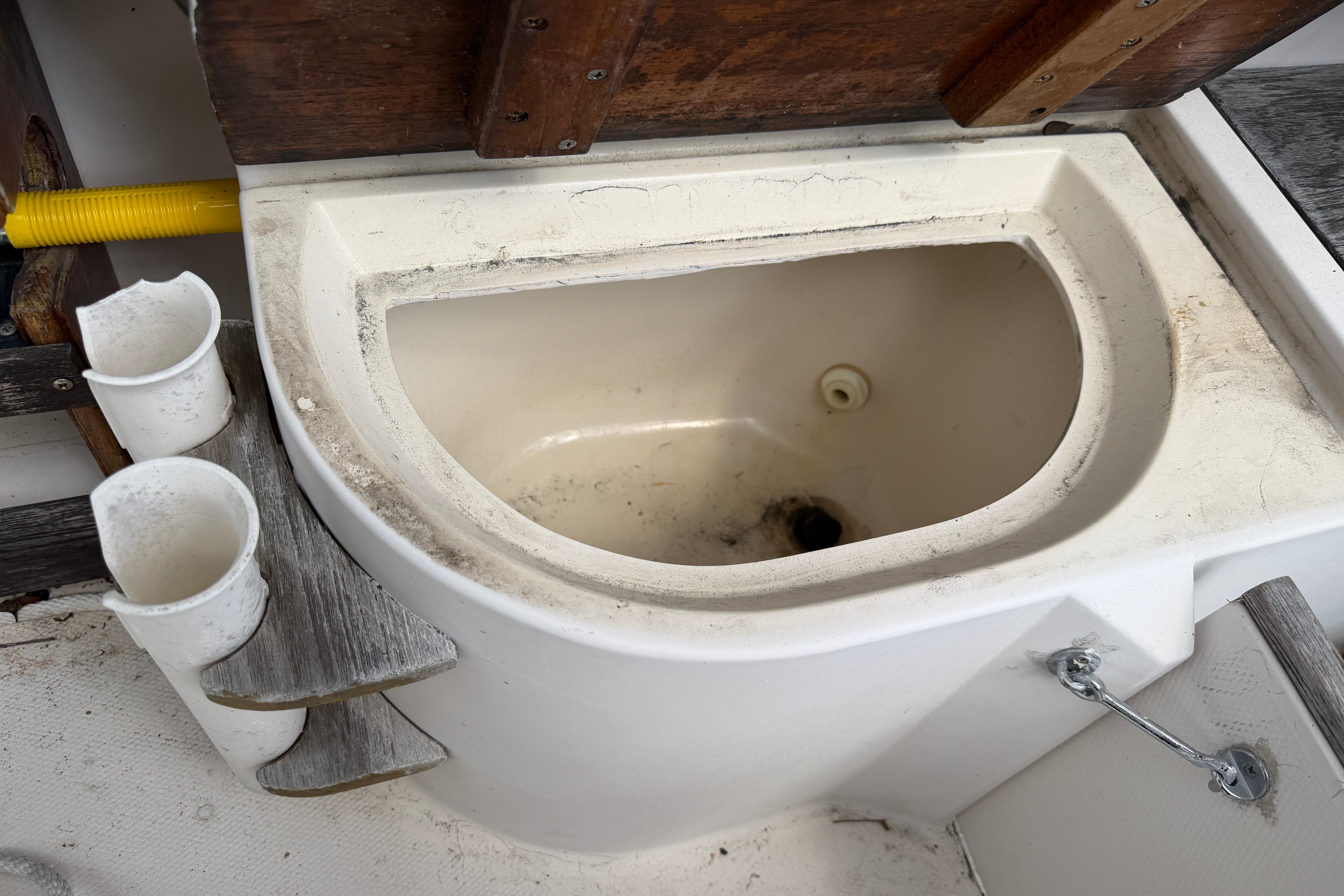 1987 Grady-White Seafarer 226 boat interior with storage compartment and cup holders.