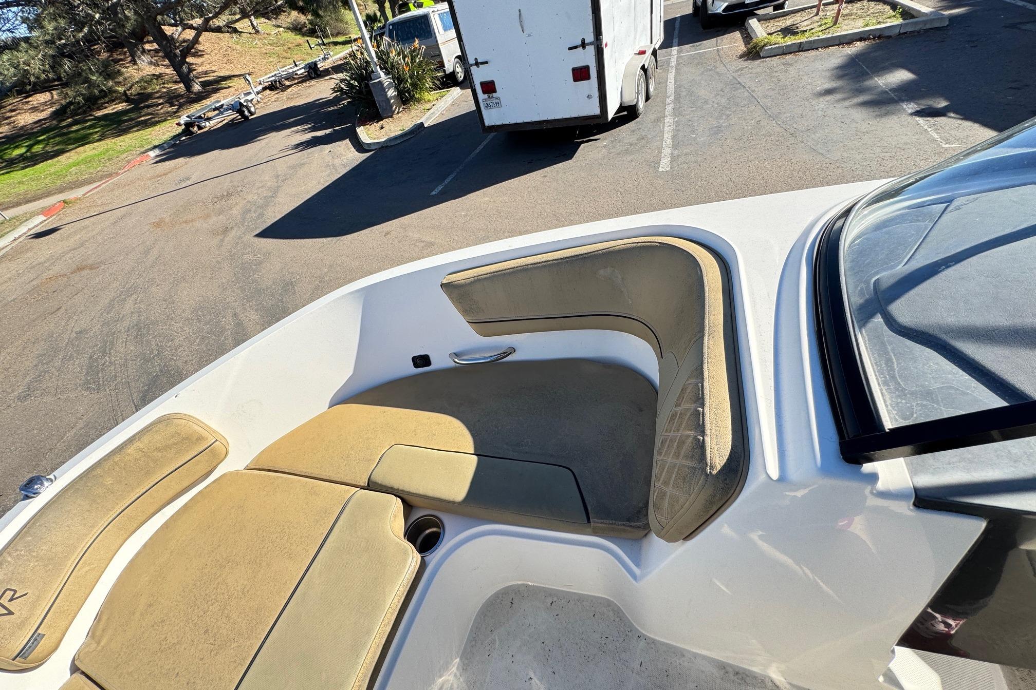 2022 Bayliner VR6 Bowrider OB boat interior with tan seating in a parking lot.