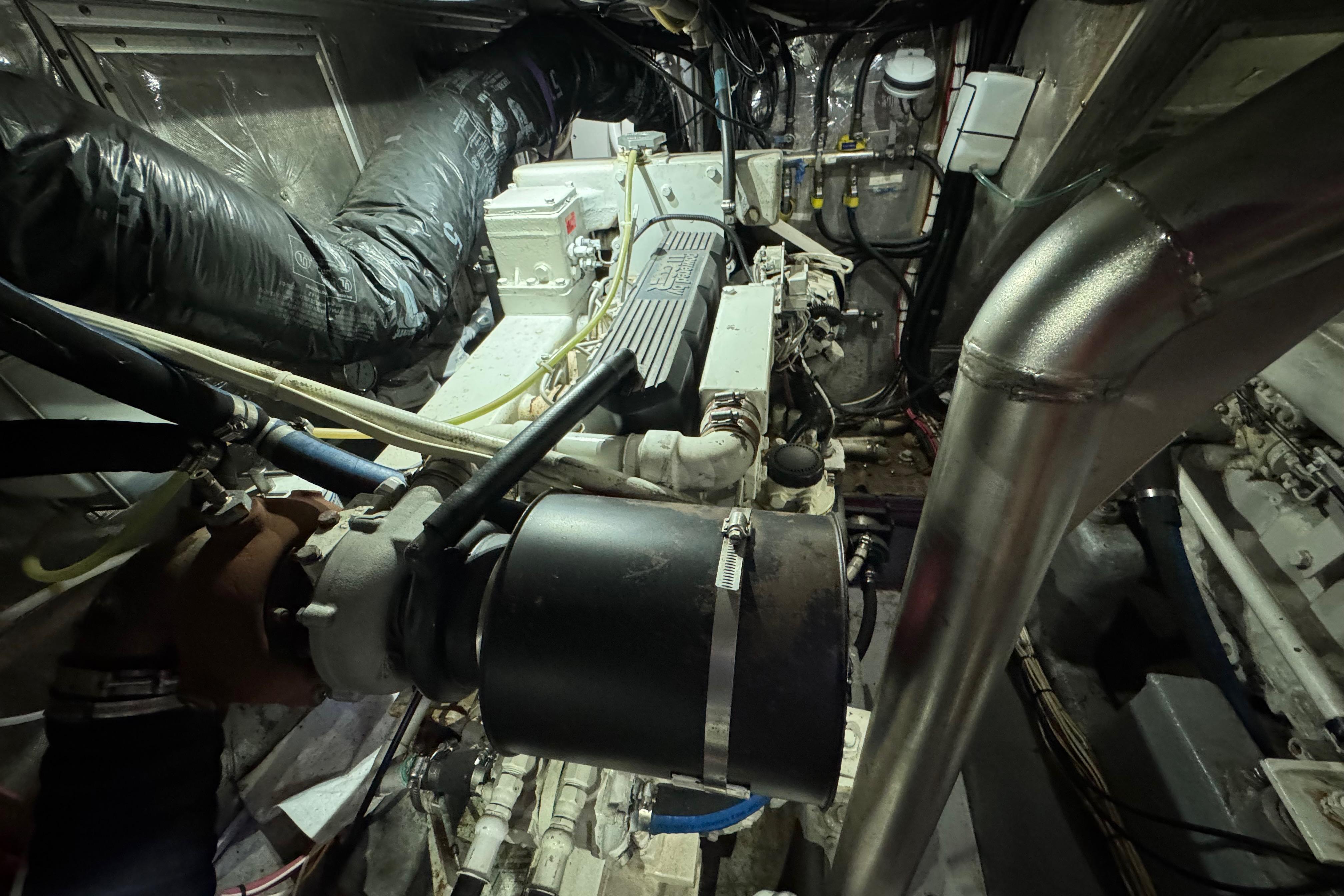 Engine room of a 1995 Nordhavn 46 yacht, showcasing mechanical components and piping.