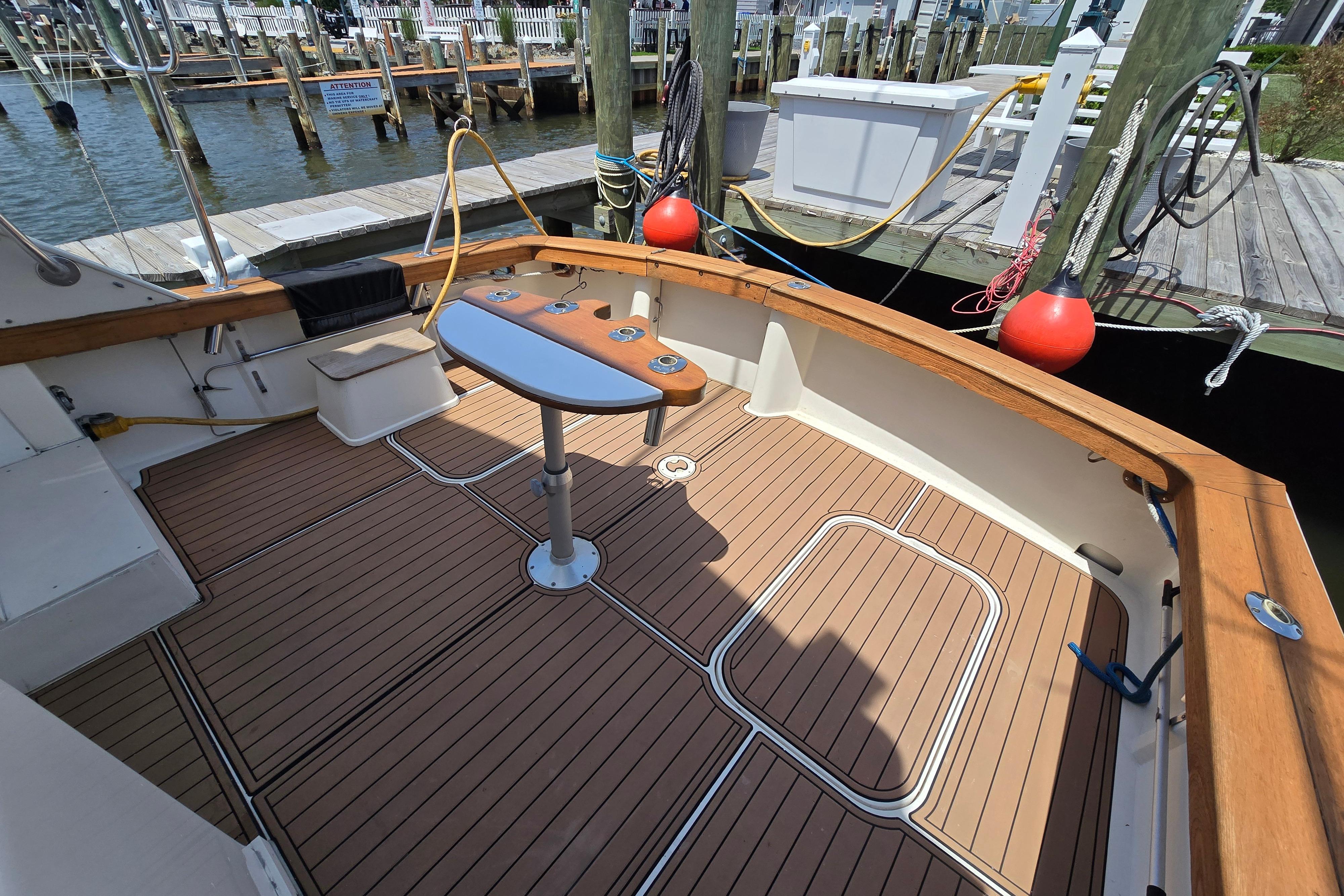 1988 Post 46 Convertible boat deck with wood finish at marina.