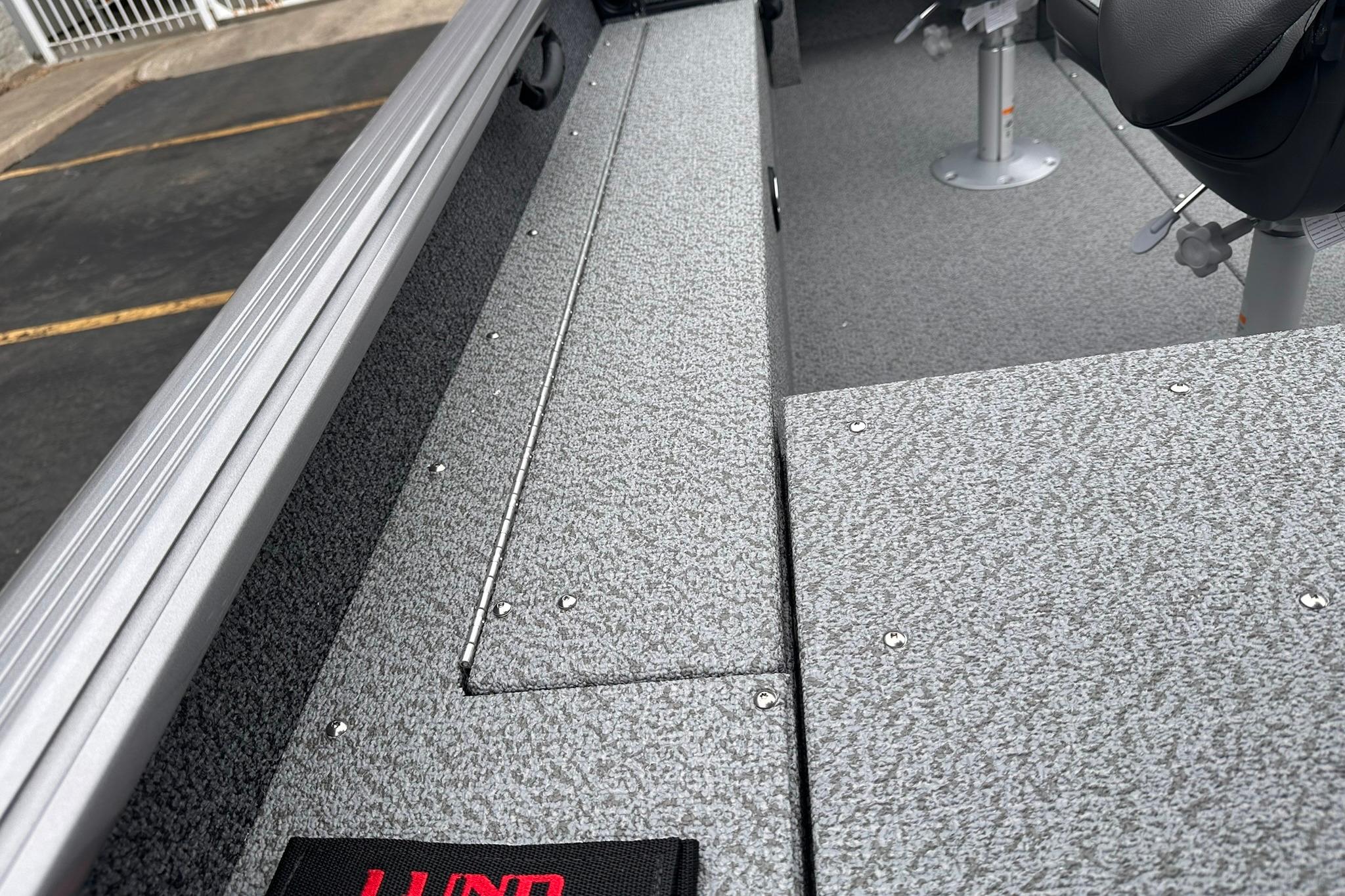 2026 Lund 1775 Impact XS Sport boat interior with textured flooring and seating.